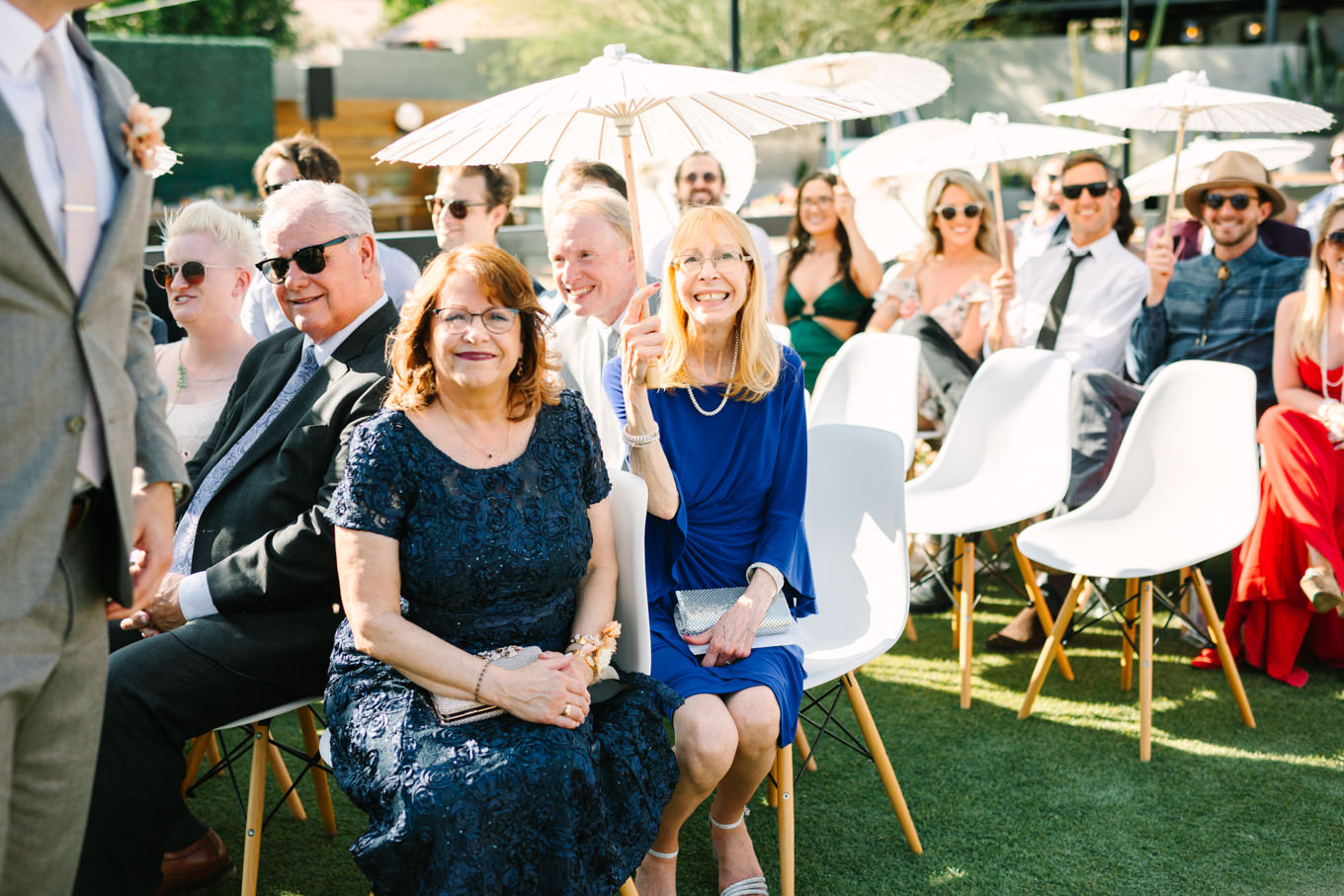 Laughing wedding guests | Pink and orange Lautner Compound wedding | Colorful Palm Springs wedding photography | #palmspringsphotographer #palmspringswedding #lautnercompound #southerncaliforniawedding  Source: Mary Costa Photography | Los Angeles
