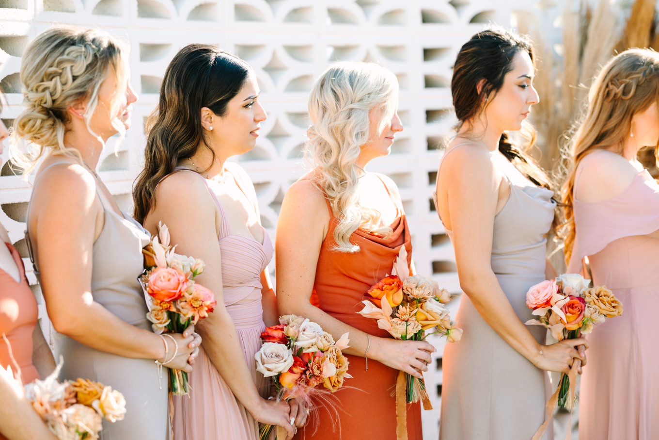 Bridesmaids at wedding ceremony | Pink and orange Lautner Compound wedding | Colorful Palm Springs wedding photography | #palmspringsphotographer #palmspringswedding #lautnercompound #southerncaliforniawedding  Source: Mary Costa Photography | Los Angeles