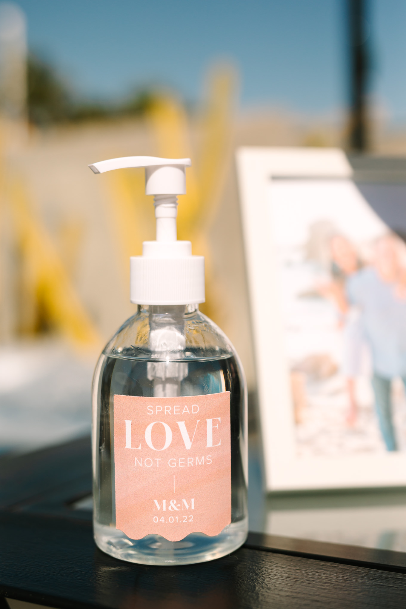 Custom hand sanitizer at cocktail hour | Pink and orange Lautner Compound wedding | Colorful Palm Springs wedding photography | #palmspringsphotographer #palmspringswedding #lautnercompound #southerncaliforniawedding  Source: Mary Costa Photography | Los Angeles