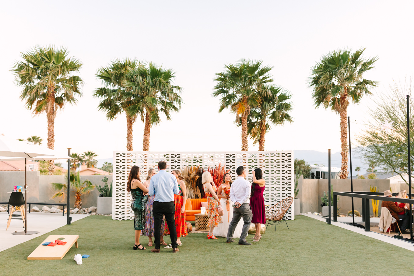Cocktail hour games | Pink and orange Lautner Compound wedding | Colorful Palm Springs wedding photography | #palmspringsphotographer #palmspringswedding #lautnercompound #southerncaliforniawedding  Source: Mary Costa Photography | Los Angeles