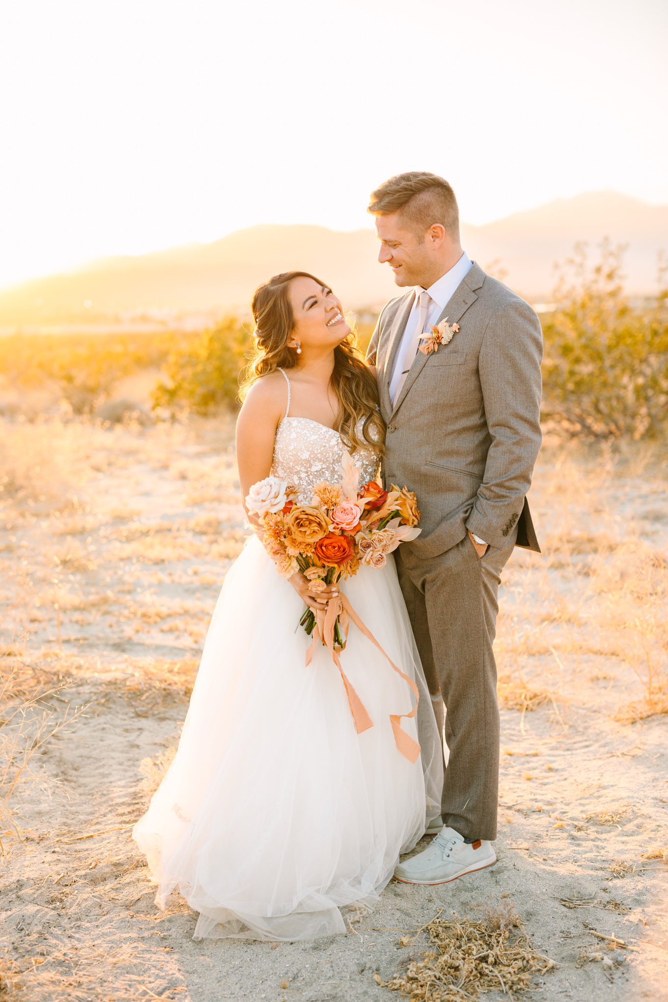 Bride and groom at sunset in the desert | Pink and orange Lautner Compound wedding | Colorful Palm Springs wedding photography | #palmspringsphotographer #palmspringswedding #lautnercompound #southerncaliforniawedding  Source: Mary Costa Photography | Los Angeles