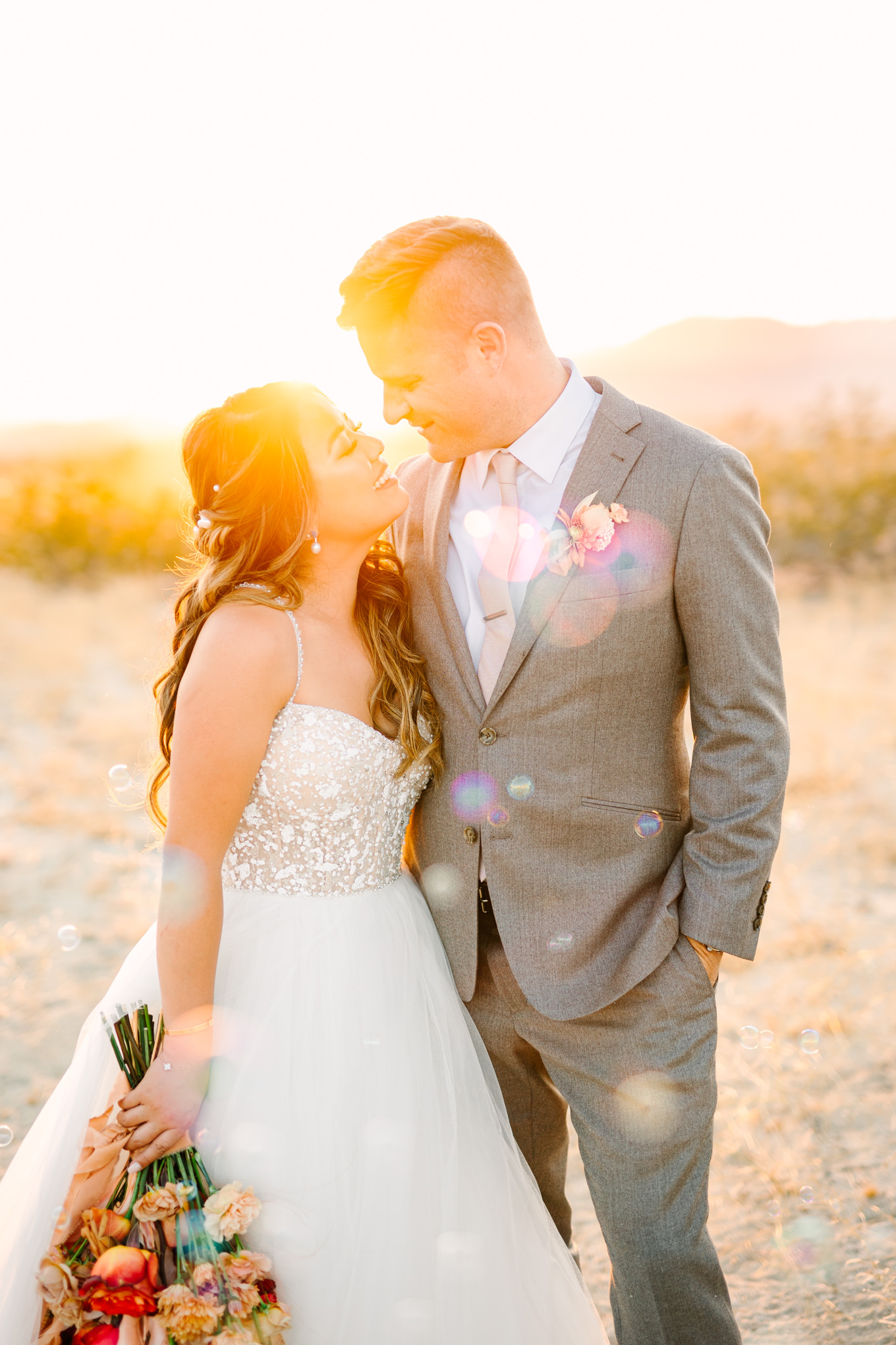 Bride and groom portrait at sunset with bubbles | Pink and orange Lautner Compound wedding | Colorful Palm Springs wedding photography | #palmspringsphotographer #palmspringswedding #lautnercompound #southerncaliforniawedding  Source: Mary Costa Photography | Los Angeles