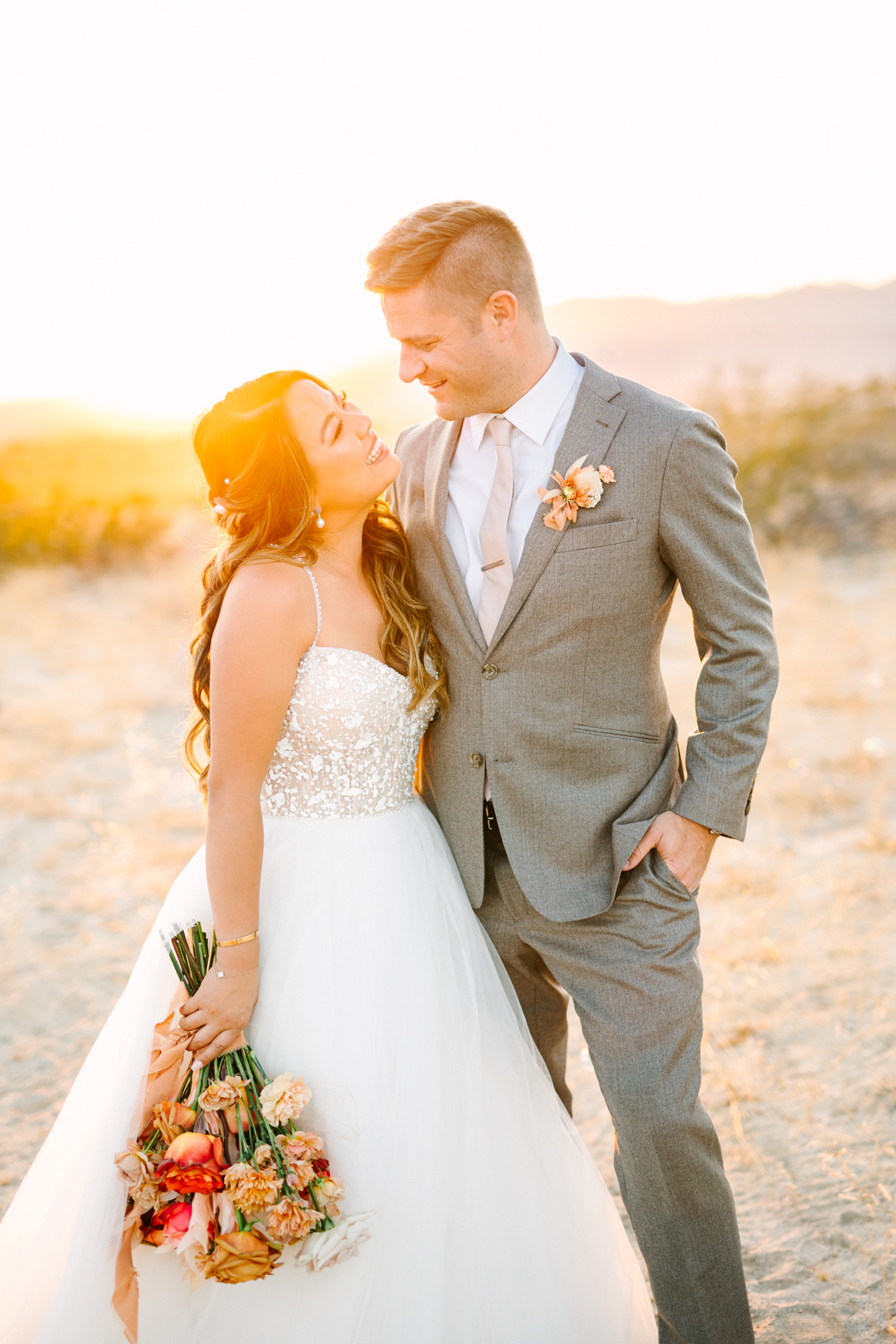 Bride and groom at sunset in the desert | Pink and orange Lautner Compound wedding | Colorful Palm Springs wedding photography | #palmspringsphotographer #palmspringswedding #lautnercompound #southerncaliforniawedding  Source: Mary Costa Photography | Los Angeles