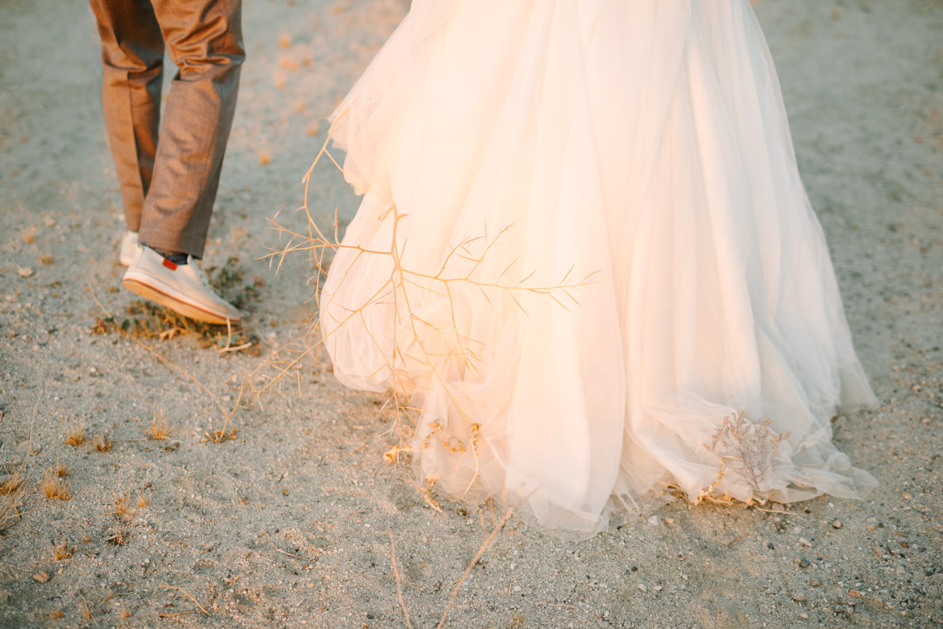 Tumbleweed stuck to bride's dress | Pink and orange Lautner Compound wedding | Colorful Palm Springs wedding photography | #palmspringsphotographer #palmspringswedding #lautnercompound #southerncaliforniawedding  Source: Mary Costa Photography | Los Angeles