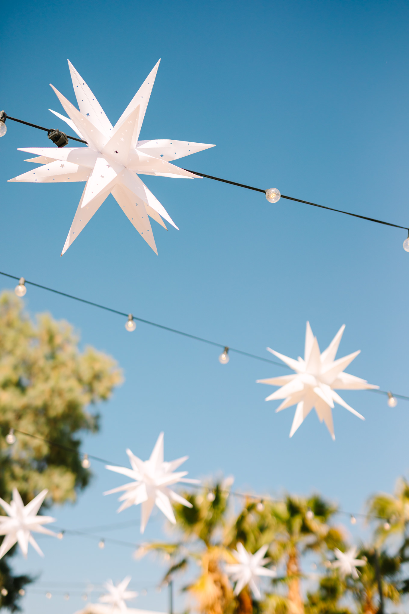 Hanging stars at wedding reception | Pink and orange Lautner Compound wedding | Colorful Palm Springs wedding photography | #palmspringsphotographer #palmspringswedding #lautnercompound #southerncaliforniawedding  Source: Mary Costa Photography | Los Angeles