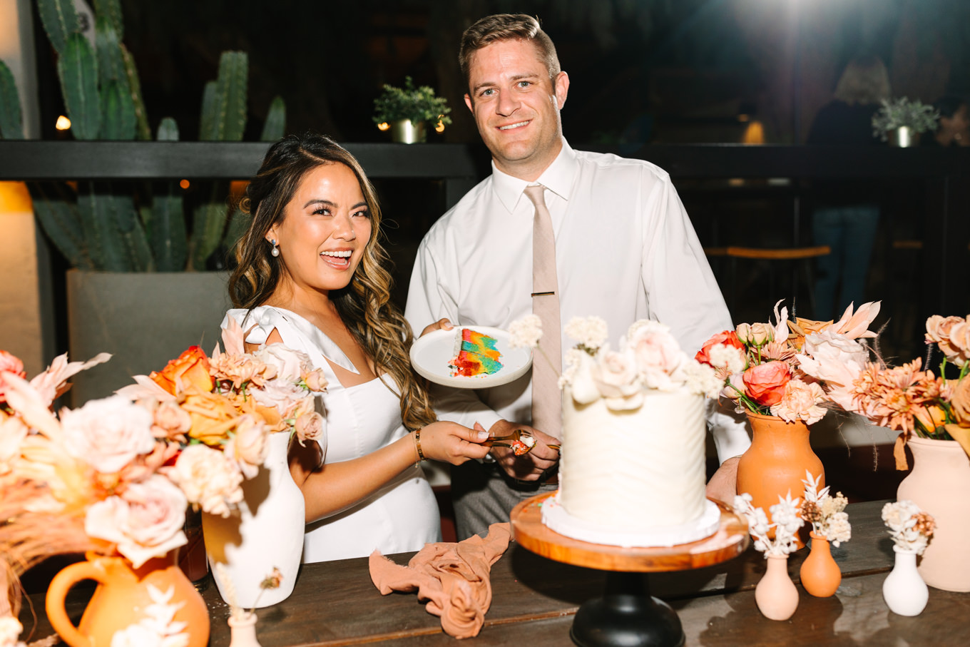 Rainbow surprise in wedding cake | Pink and orange Lautner Compound wedding | Colorful Palm Springs wedding photography | #palmspringsphotographer #palmspringswedding #lautnercompound #southerncaliforniawedding  Source: Mary Costa Photography | Los Angeles