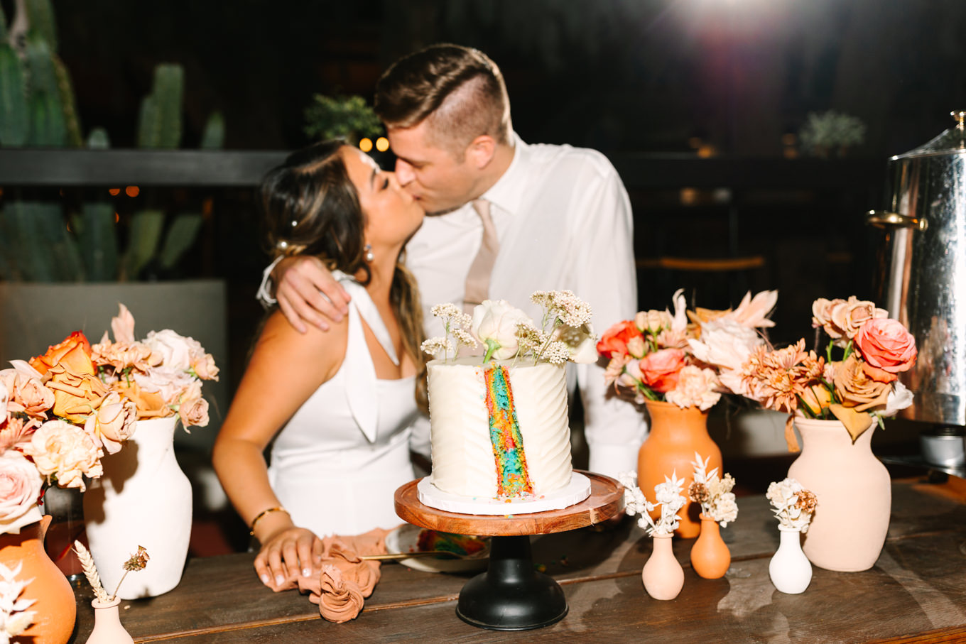 Rainbow surprise in wedding cake | Pink and orange Lautner Compound wedding | Colorful Palm Springs wedding photography | #palmspringsphotographer #palmspringswedding #lautnercompound #southerncaliforniawedding  Source: Mary Costa Photography | Los Angeles