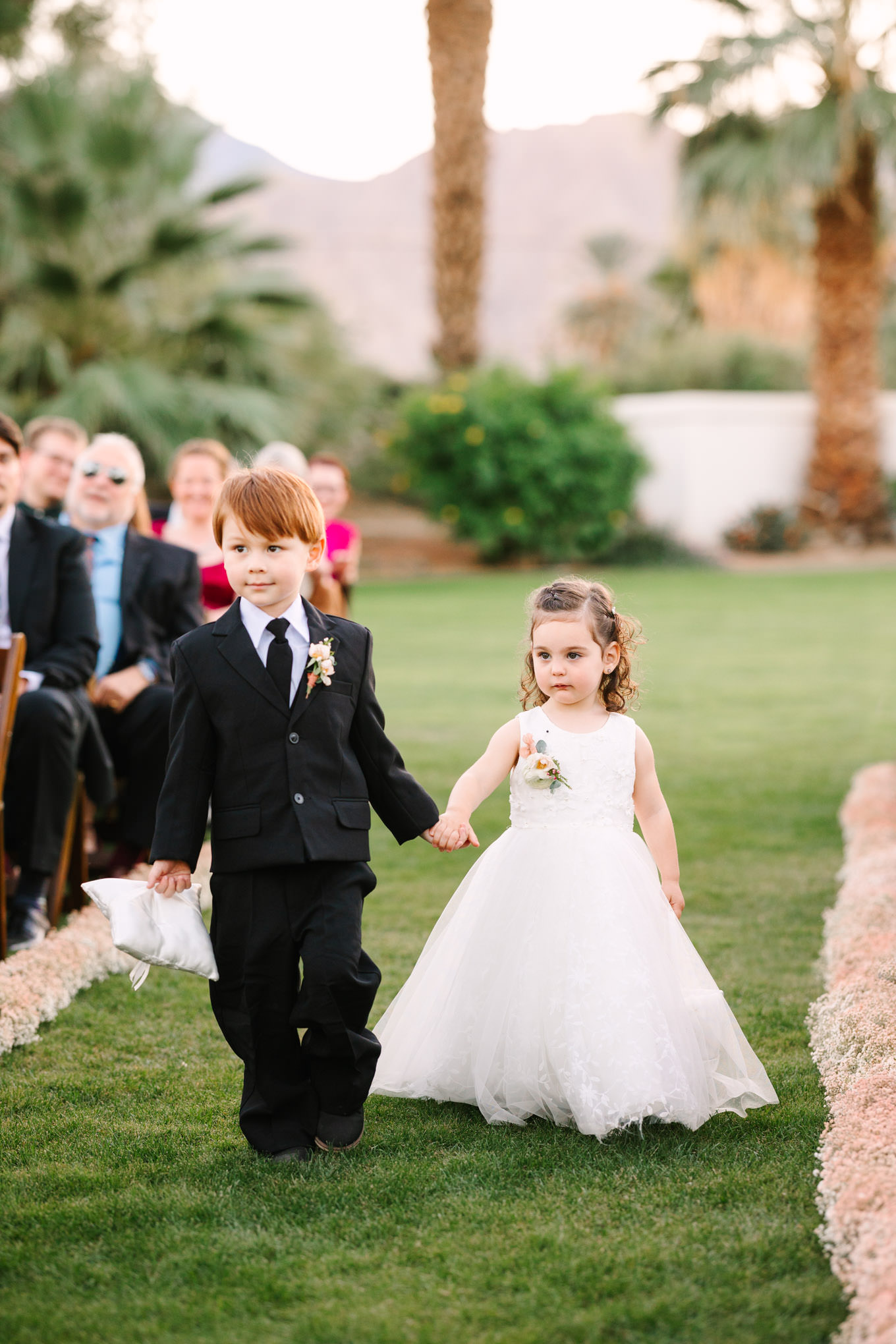 Flower girl and ring bearer | Pink Bougainvillea Estate wedding | Colorful LA wedding photography | #bougainvilleaestate #palmspringswedding #palmspringsweddingvenue #palmspringsphotographer Source: Mary Costa Photography | Los Angeles