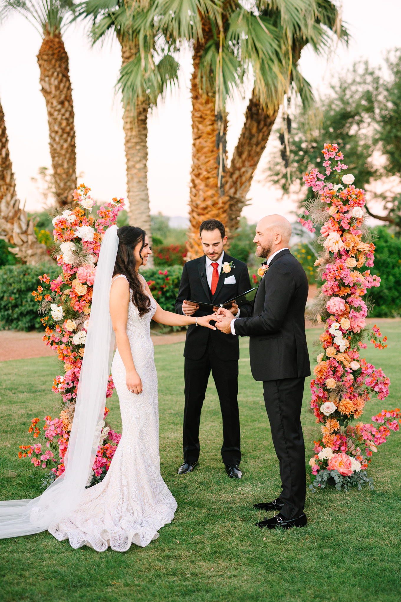 Couple exchanging rings | Pink Bougainvillea Estate wedding | Colorful LA wedding photography | #bougainvilleaestate #palmspringswedding #palmspringsweddingvenue #palmspringsphotographer Source: Mary Costa Photography | Los Angeles