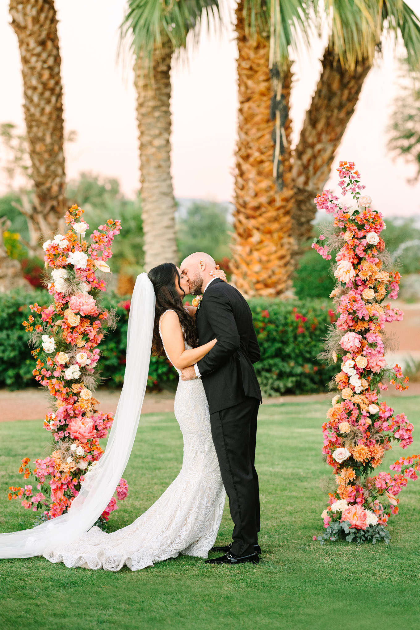 The ceremony kiss | Pink Bougainvillea Estate wedding | Colorful LA wedding photography | #bougainvilleaestate #palmspringswedding #palmspringsweddingvenue #palmspringsphotographer Source: Mary Costa Photography | Los Angeles