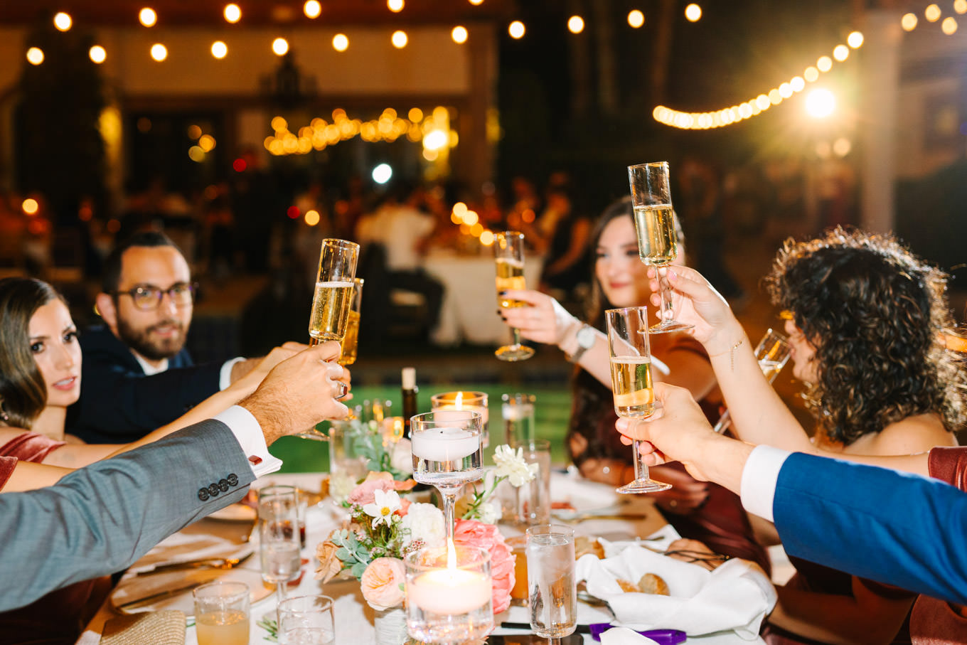 Guests toasting | Pink Bougainvillea Estate wedding | Colorful LA wedding photography | #bougainvilleaestate #palmspringswedding #palmspringsweddingvenue #palmspringsphotographer Source: Mary Costa Photography | Los Angeles