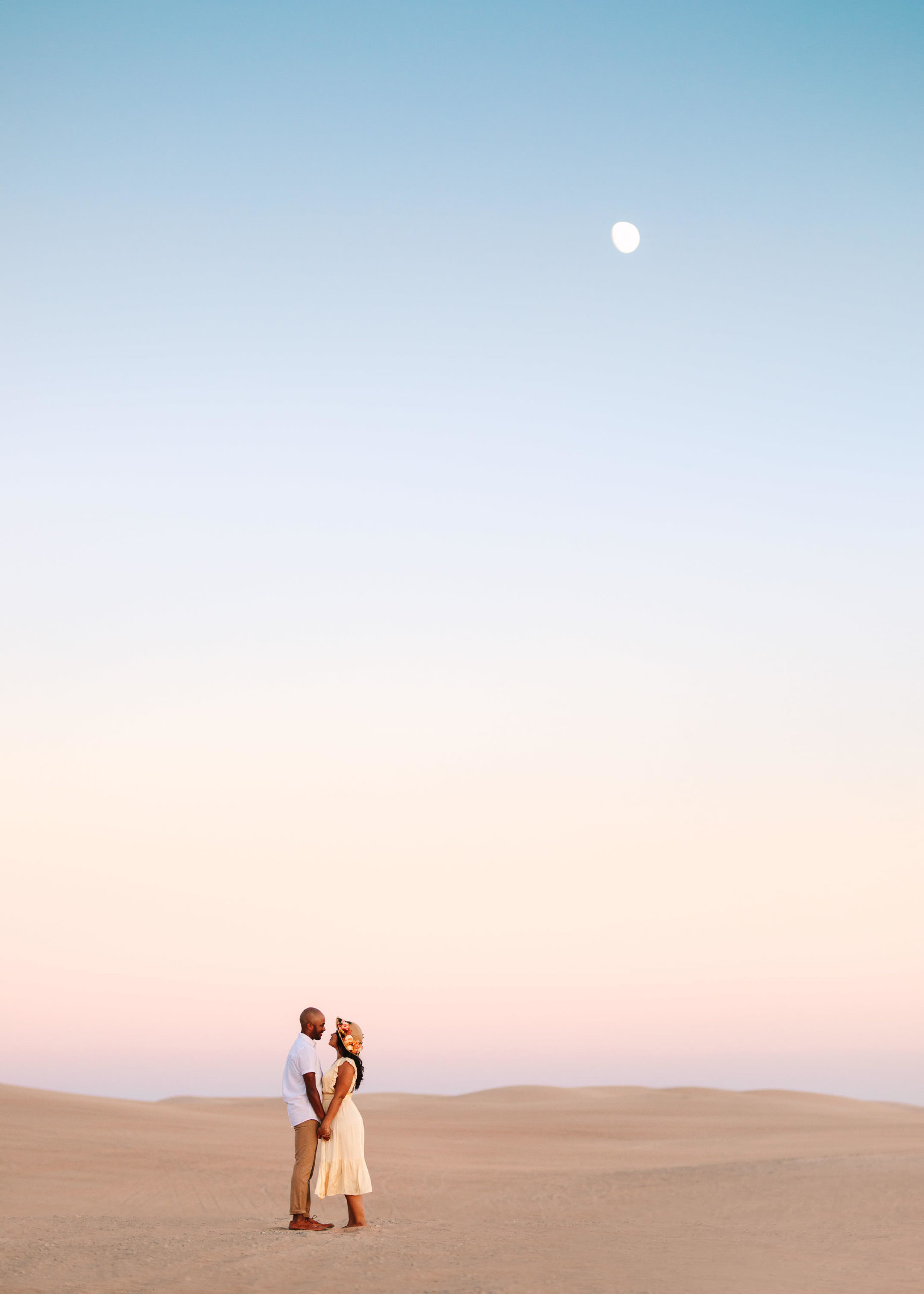 Couple in the sand dunes with the moon out | California Sand Dunes engagement session | Colorful Palm Springs wedding photography | #palmspringsphotographer #sanddunes #engagementsession #southerncalifornia  Source: Mary Costa Photography | Los Angeles