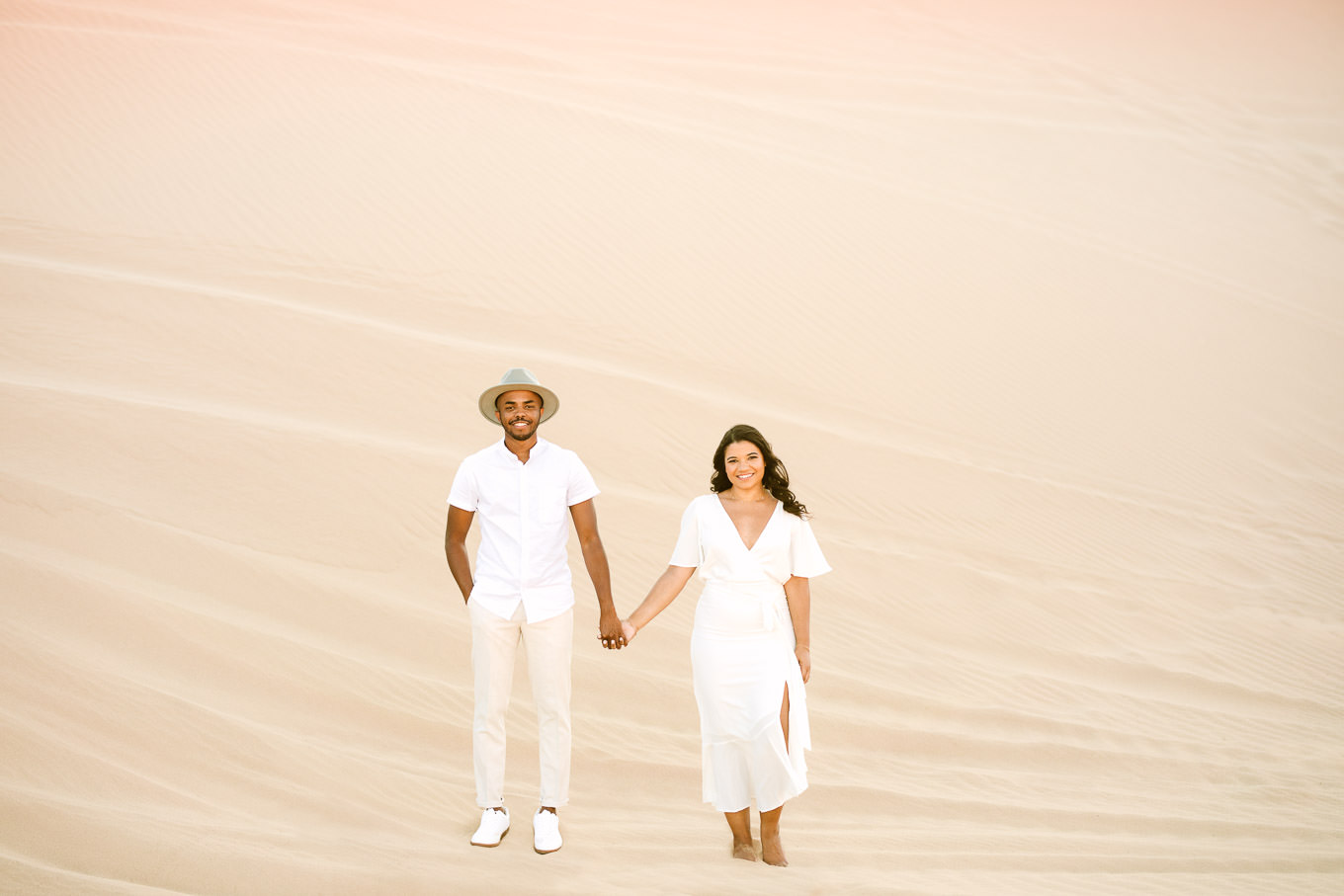 All white outfits for engagement session | California Sand Dunes engagement session | Colorful Palm Springs wedding photography | #palmspringsphotographer #sanddunes #engagementsession #southerncalifornia  Source: Mary Costa Photography | Los Angeles