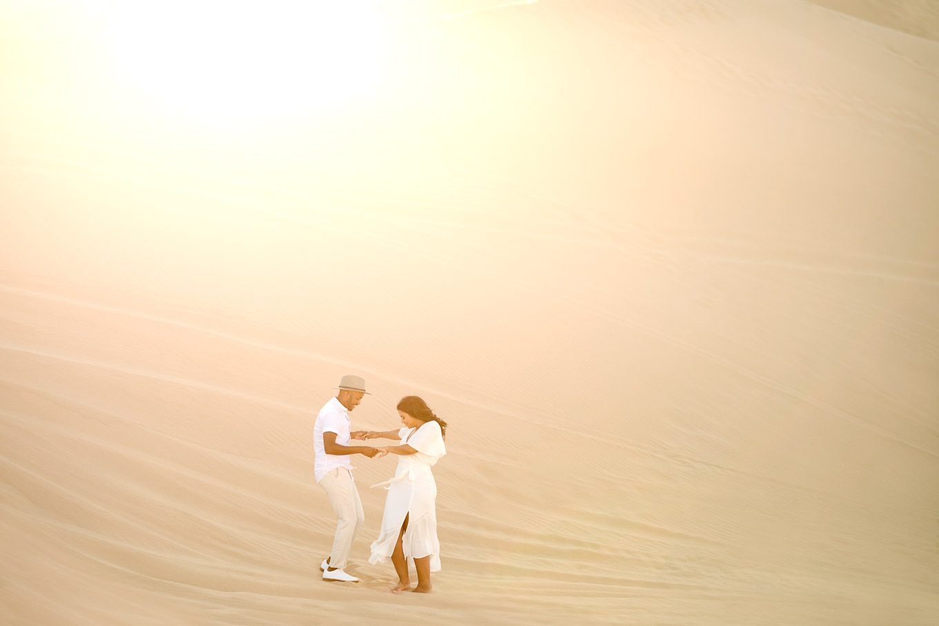 Engaged couple dance on sand dune | California Sand Dunes engagement session | Colorful Palm Springs wedding photography | #palmspringsphotographer #sanddunes #engagementsession #southerncalifornia  Source: Mary Costa Photography | Los Angeles