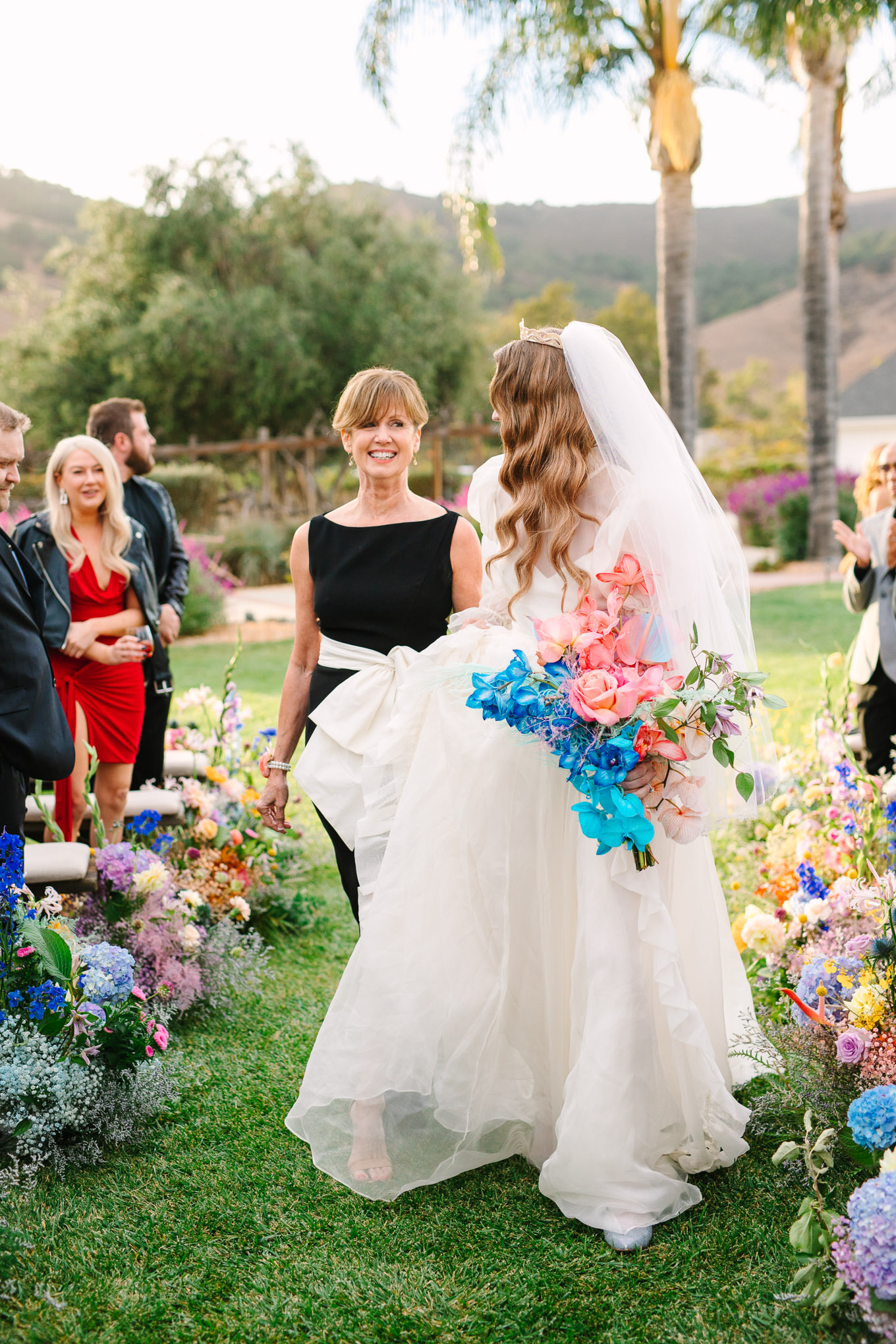 Bride Allison Harvard walking down the aisle at wedding ceremony | Colorful and quirky wedding at Higuera Ranch in San Luis Obispo | #sanluisobispowedding #californiawedding #higueraranch #madonnainn   
Source: Mary Costa Photography | Los Angeles