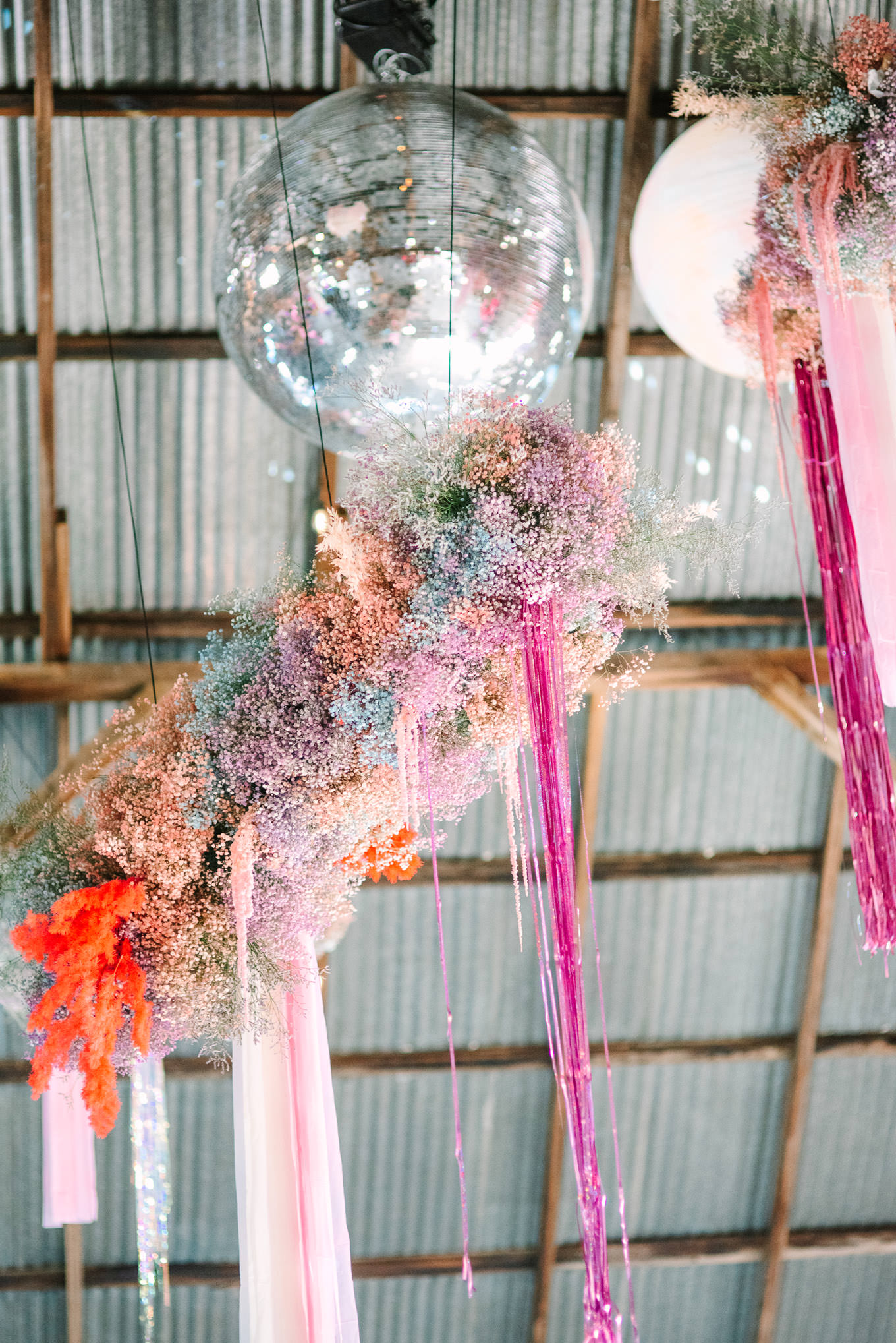 Whimsical disco ball and baby's breath wedding reception installation | Colorful and quirky wedding at Higuera Ranch in San Luis Obispo | #sanluisobispowedding #californiawedding #higueraranch #madonnainn   Source: Mary Costa Photography | Los Angeles