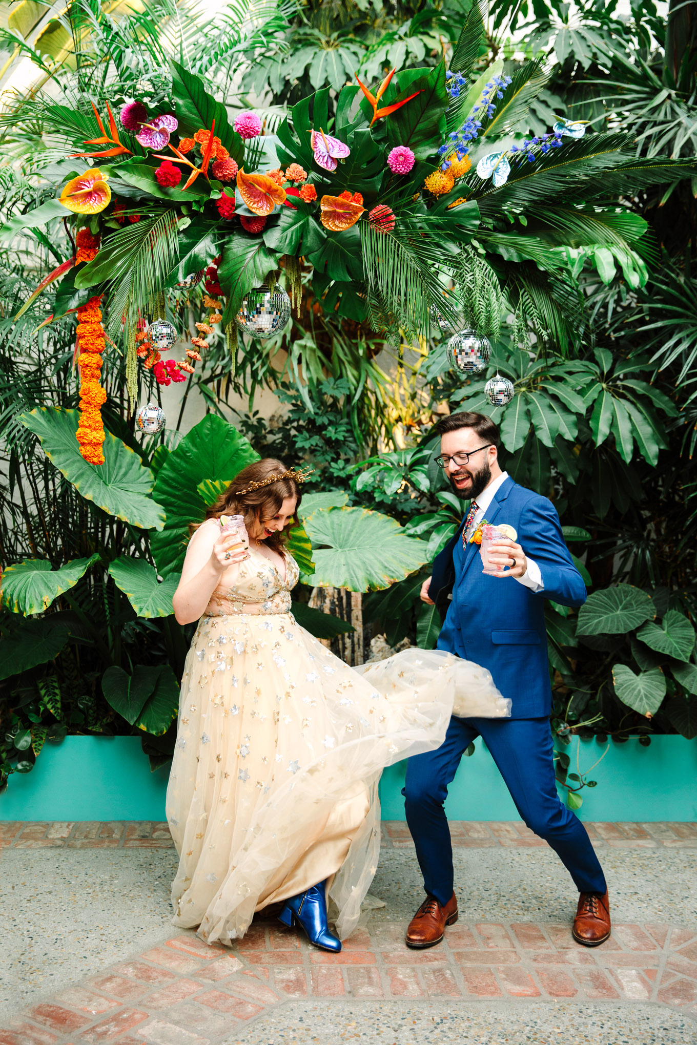 Bride and groom celebrating among tropical plants | Colorful Downtown Los Angeles Valentine Wedding | Los Angeles wedding photographer | #losangeleswedding #colorfulwedding #DTLA #valentinedtla   Source: Mary Costa Photography | Los Angeles