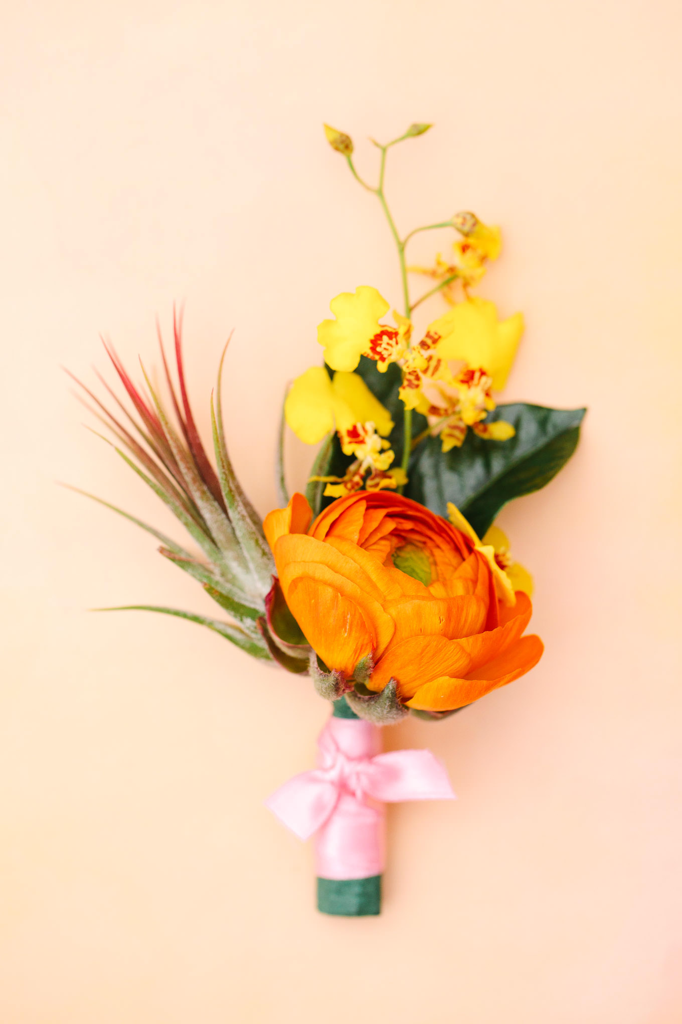 Orange groom's boutonniere | | Colorful Downtown Los Angeles Valentine Wedding | Los Angeles wedding photographer | #losangeleswedding #colorfulwedding #DTLA #valentinedtla   Source: Mary Costa Photography | Los Angeles