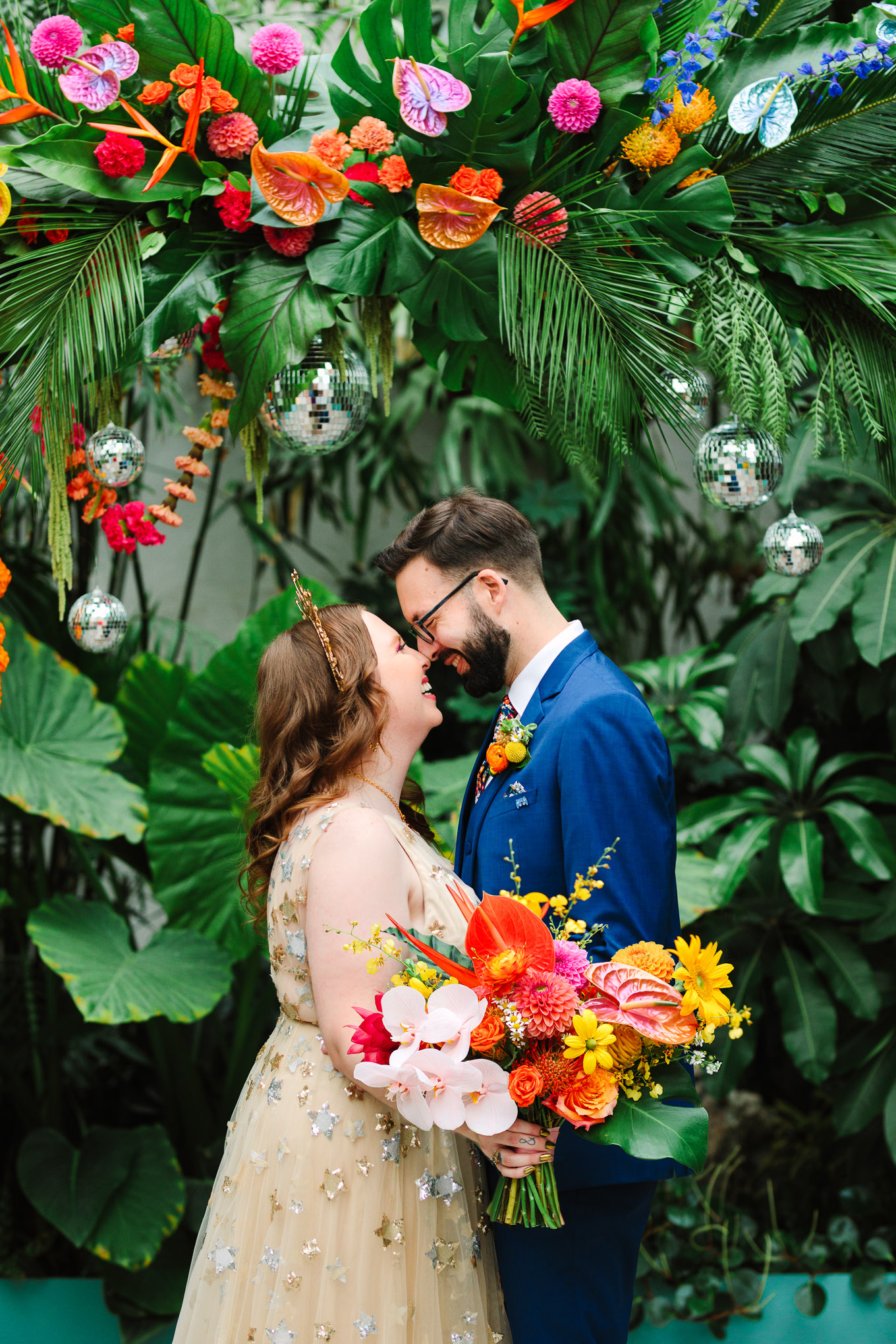 Bride and groom in front of tropical installation | Colorful Downtown Los Angeles Valentine Wedding | Los Angeles wedding photographer | #losangeleswedding #colorfulwedding #DTLA #valentinedtla   Source: Mary Costa Photography | Los Angeles