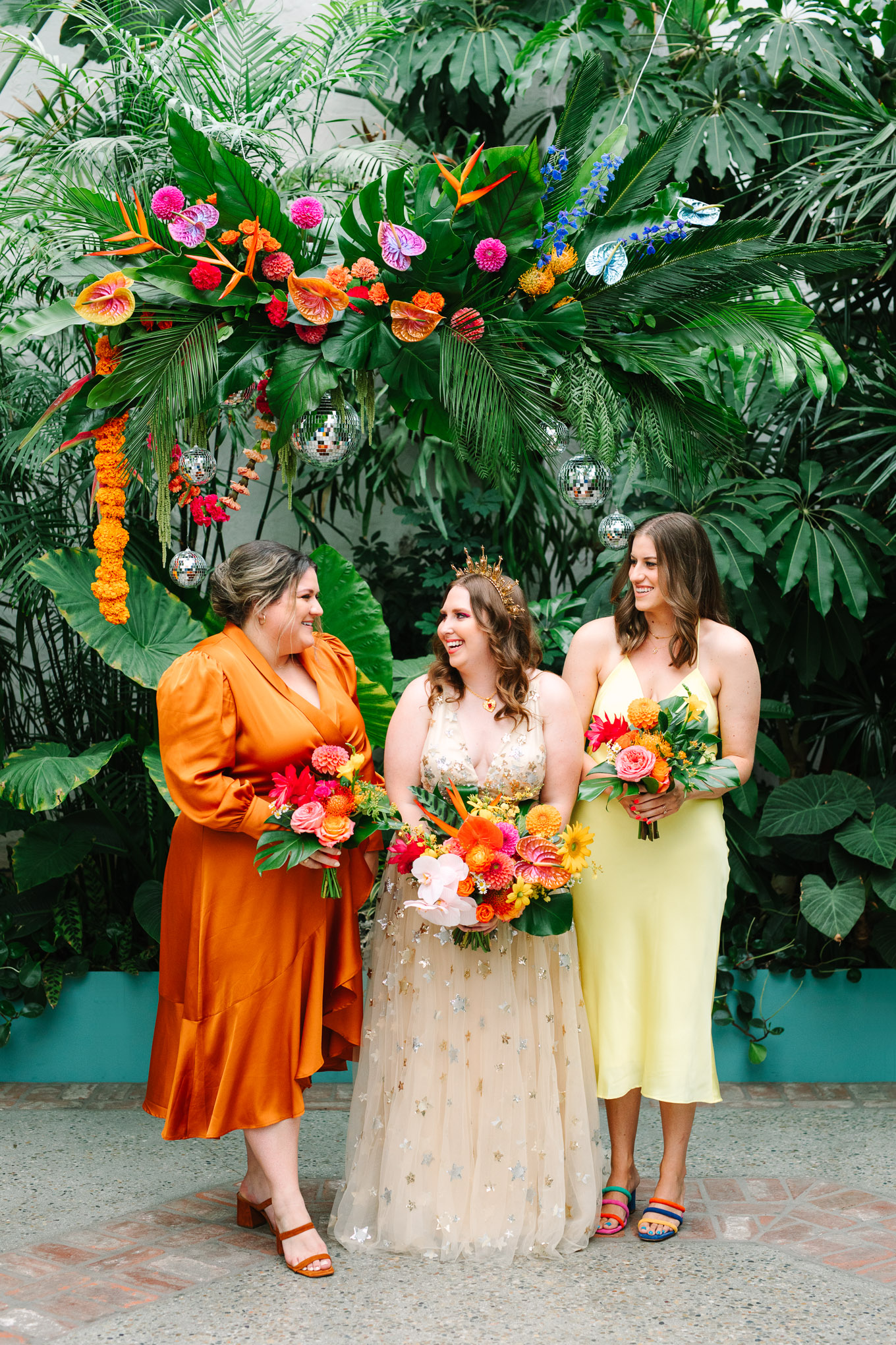 Bridesmaids with tropical ceremony installation | Colorful Downtown Los Angeles Valentine Wedding | Los Angeles wedding photographer | #losangeleswedding #colorfulwedding #DTLA #valentinedtla   Source: Mary Costa Photography | Los Angeles