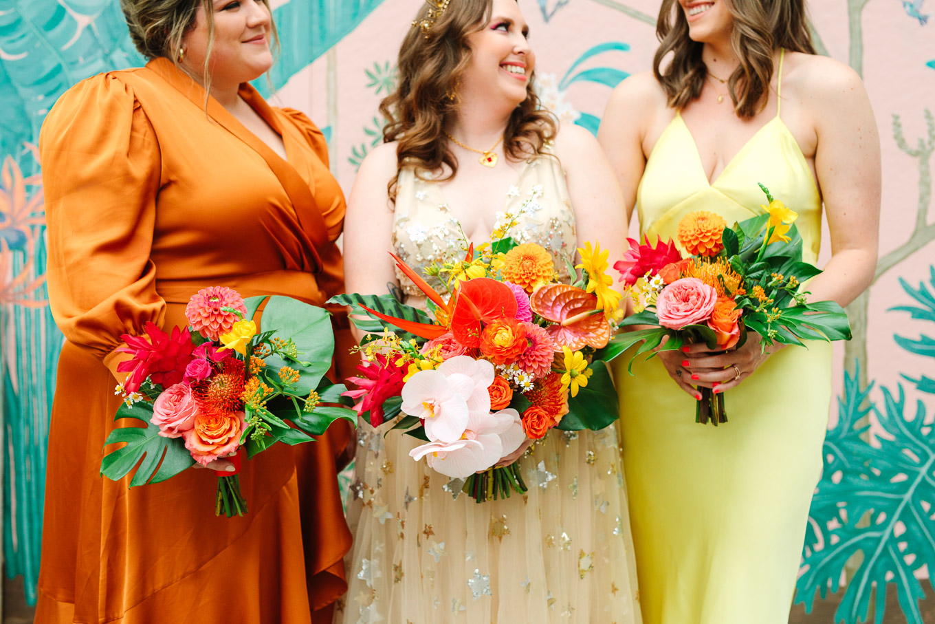 Bridesmaids with tropical bouquets | Colorful Downtown Los Angeles Valentine Wedding | Los Angeles wedding photographer | #losangeleswedding #colorfulwedding #DTLA #valentinedtla   Source: Mary Costa Photography | Los Angeles