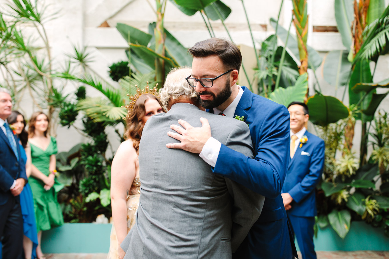 Groom hugging father of the bride | Colorful Downtown Los Angeles Valentine Wedding | Los Angeles wedding photographer | #losangeleswedding #colorfulwedding #DTLA #valentinedtla   Source: Mary Costa Photography | Los Angeles
