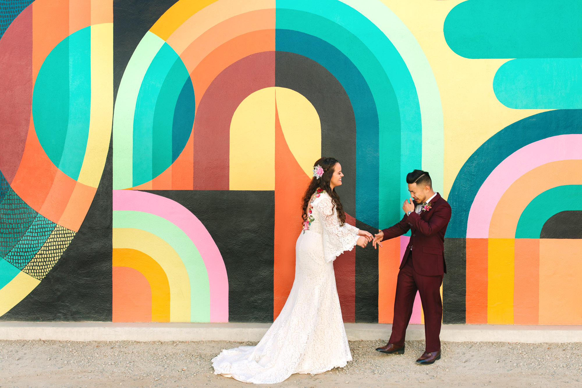 Bride and groom first look in front of colorful Sacramento mural by Mary Costa Photography
