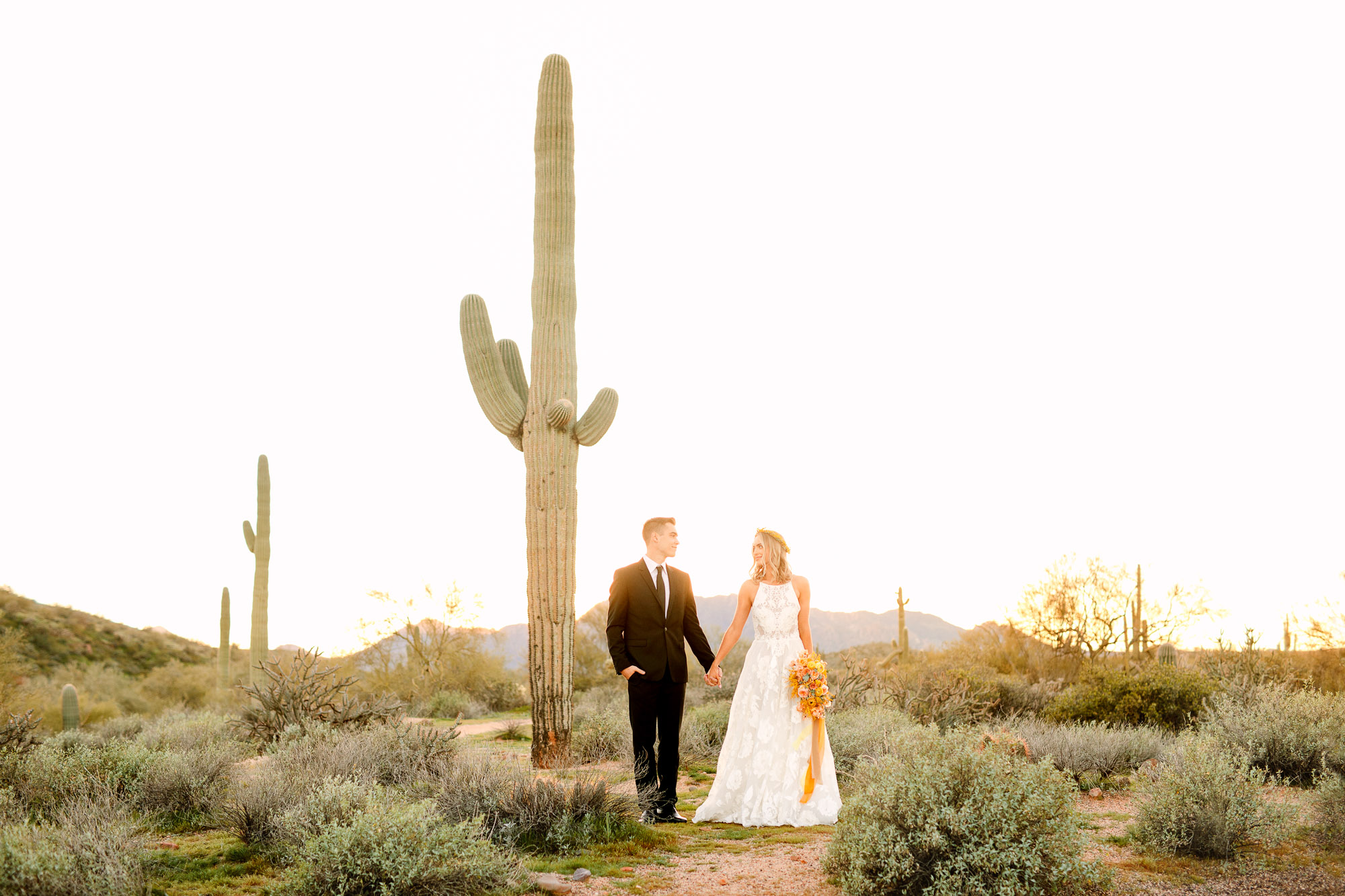 Couple with Saguaro cactus in Arizona by Mary Costa Photography