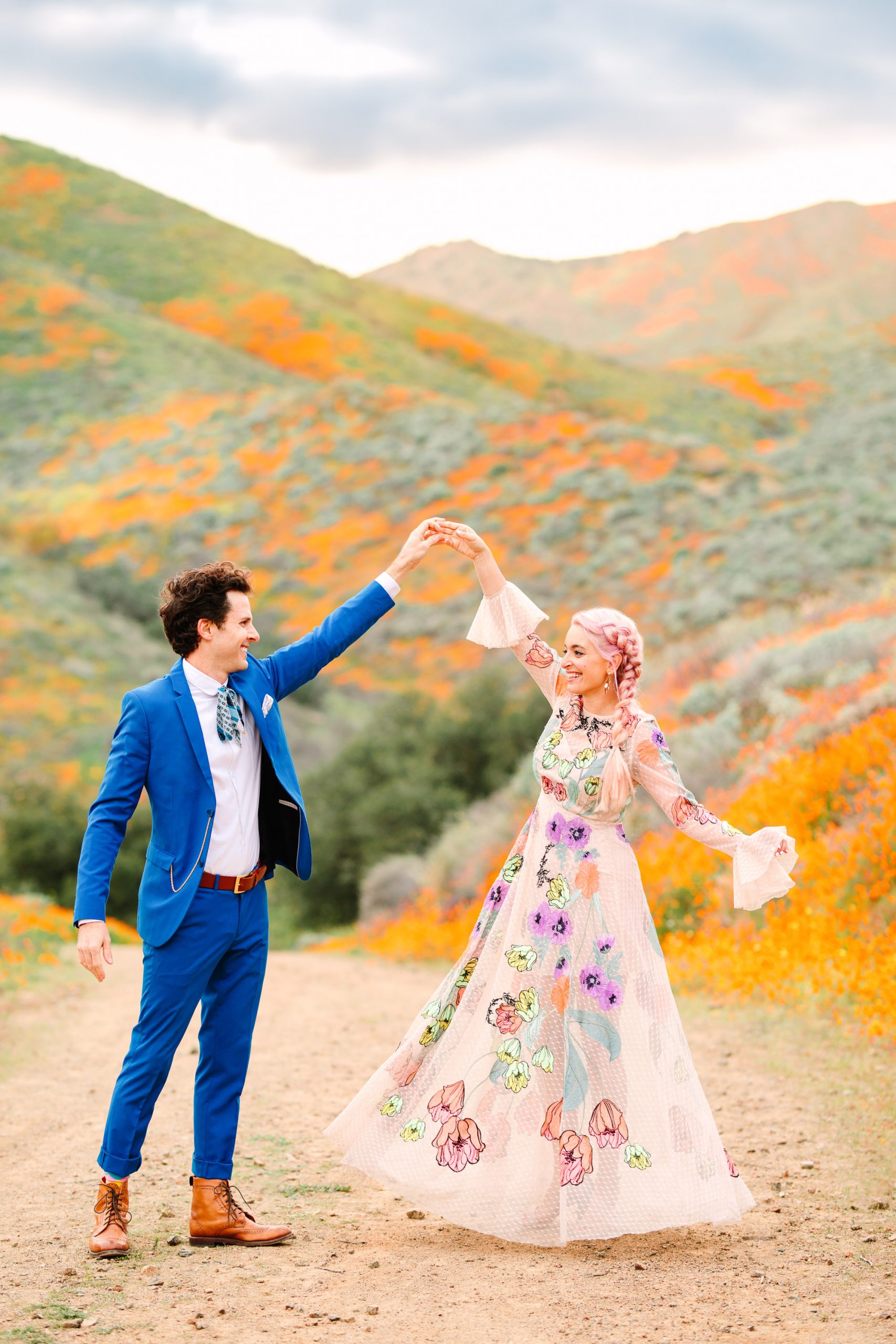 Colorful couple in poppy field by Mary Costa Photography