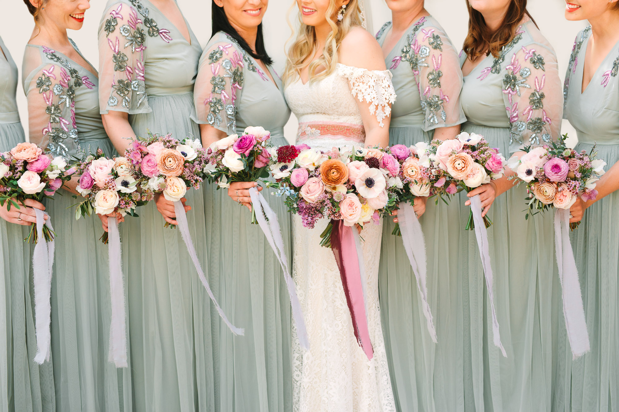 Bride and bridesmaids with bouquets by Mary Costa Photography