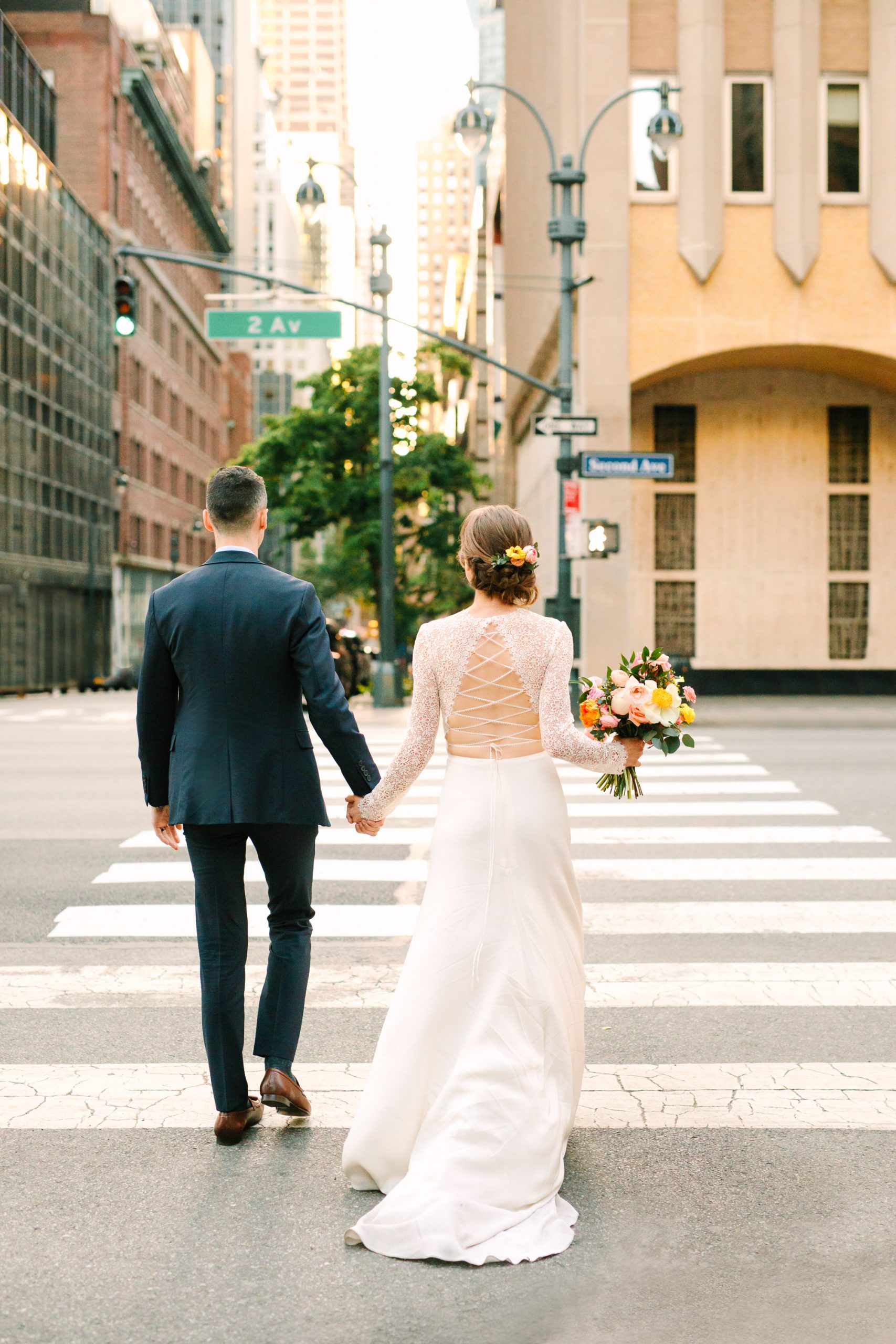 Bride and groom walking on NYC street by Mary Costa Photography