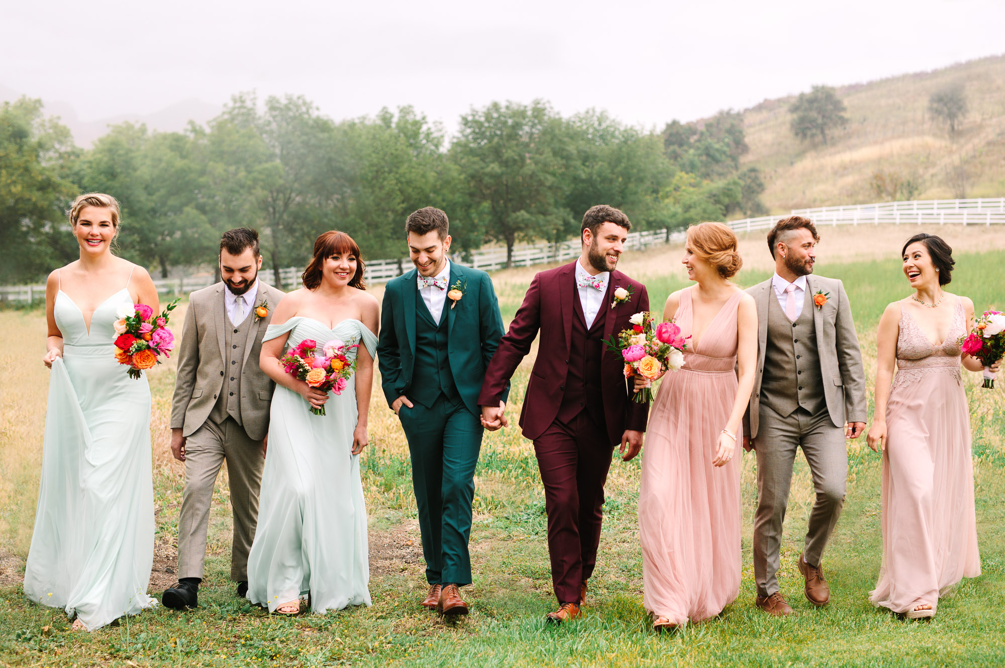 Stylish wedding party walking by Mary Costa Photography