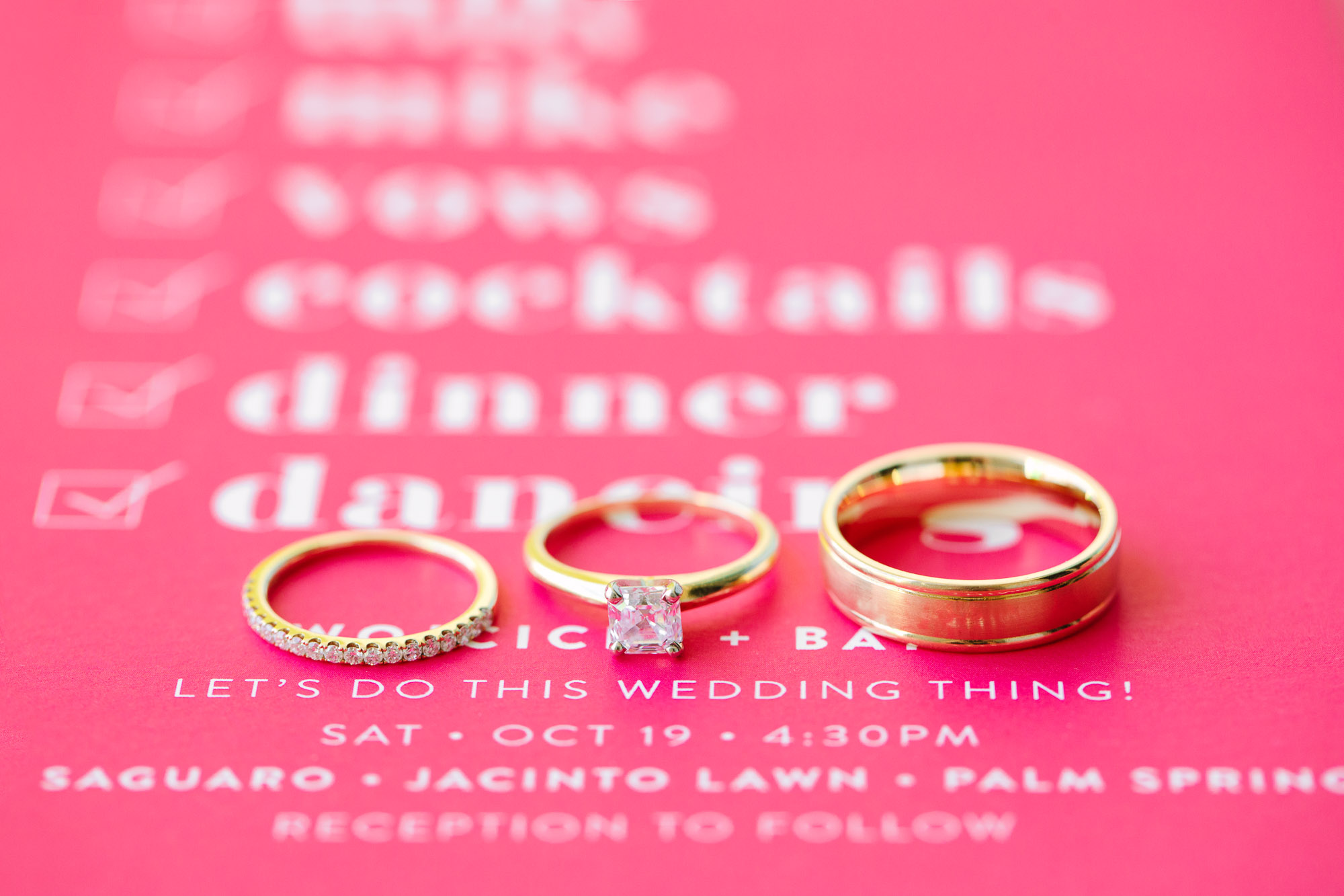 Wedding rings on pink invitation www.marycostaweddings.com