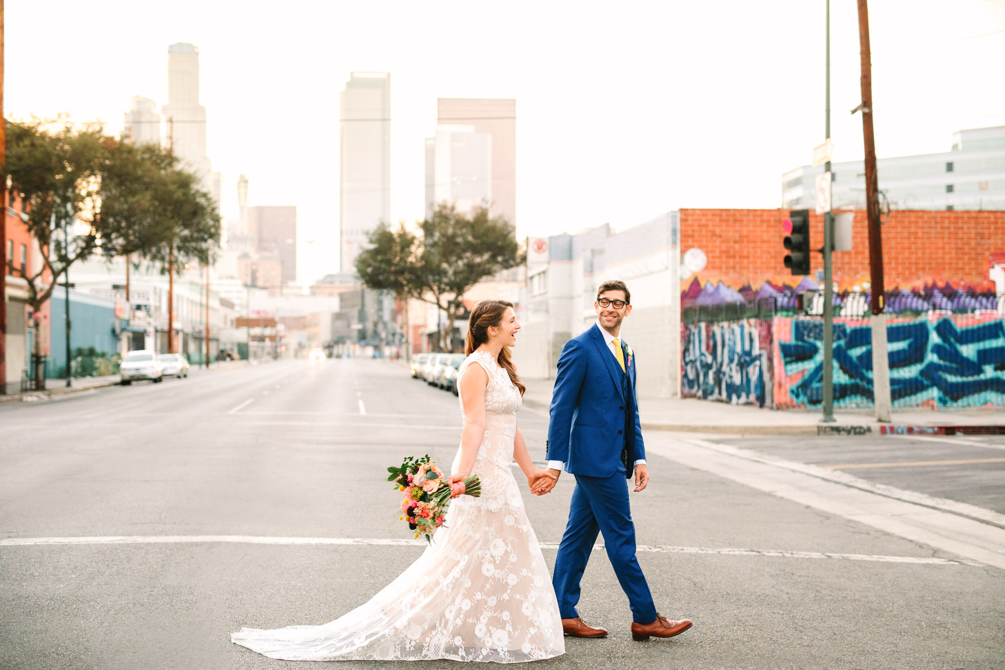 Bride and groom walking in Downtown Los Angeles near Valentine venue - www.marycostaweddings.com