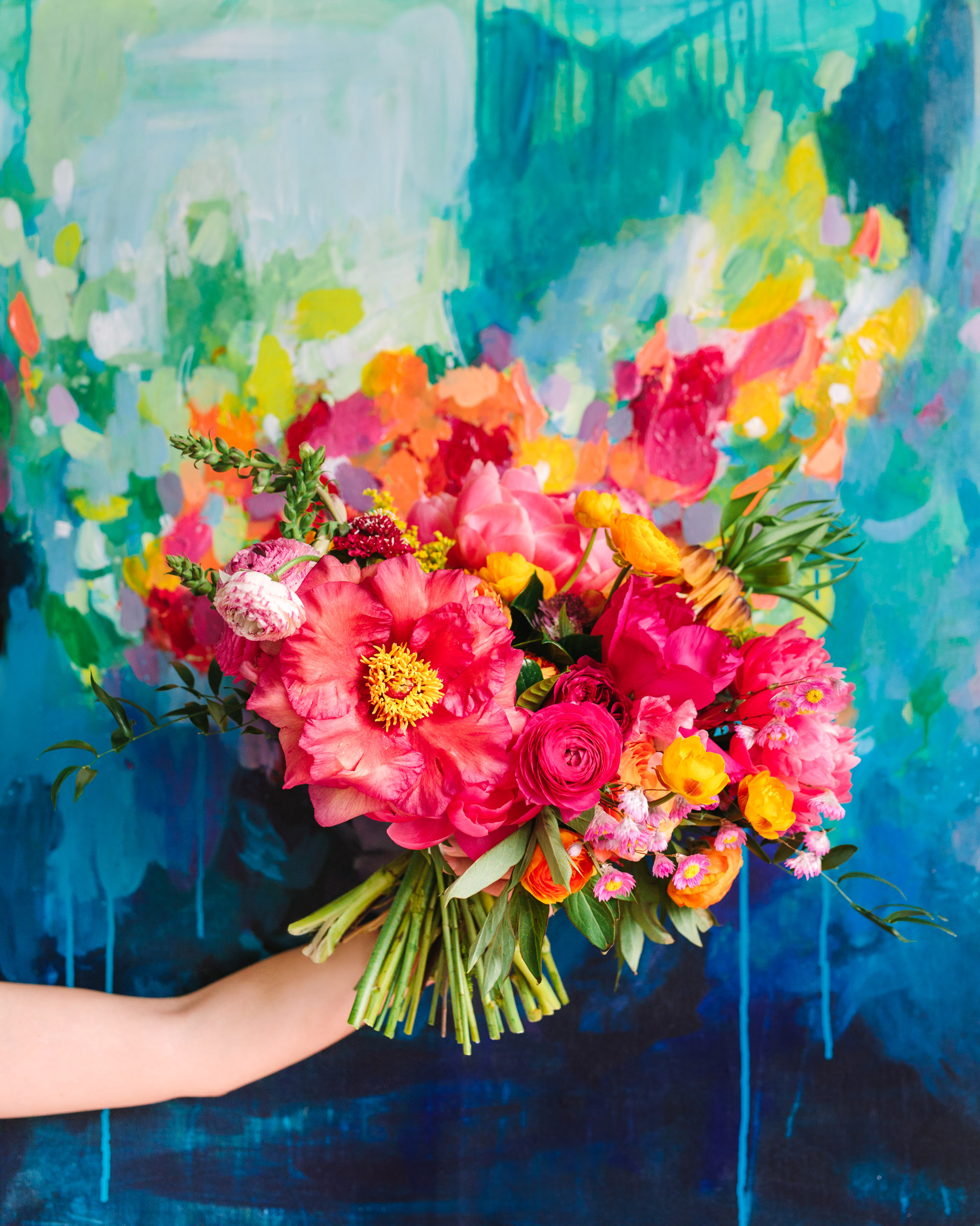 Colorful bouquet in front of painting at Fig House - www.marycostaweddings.com