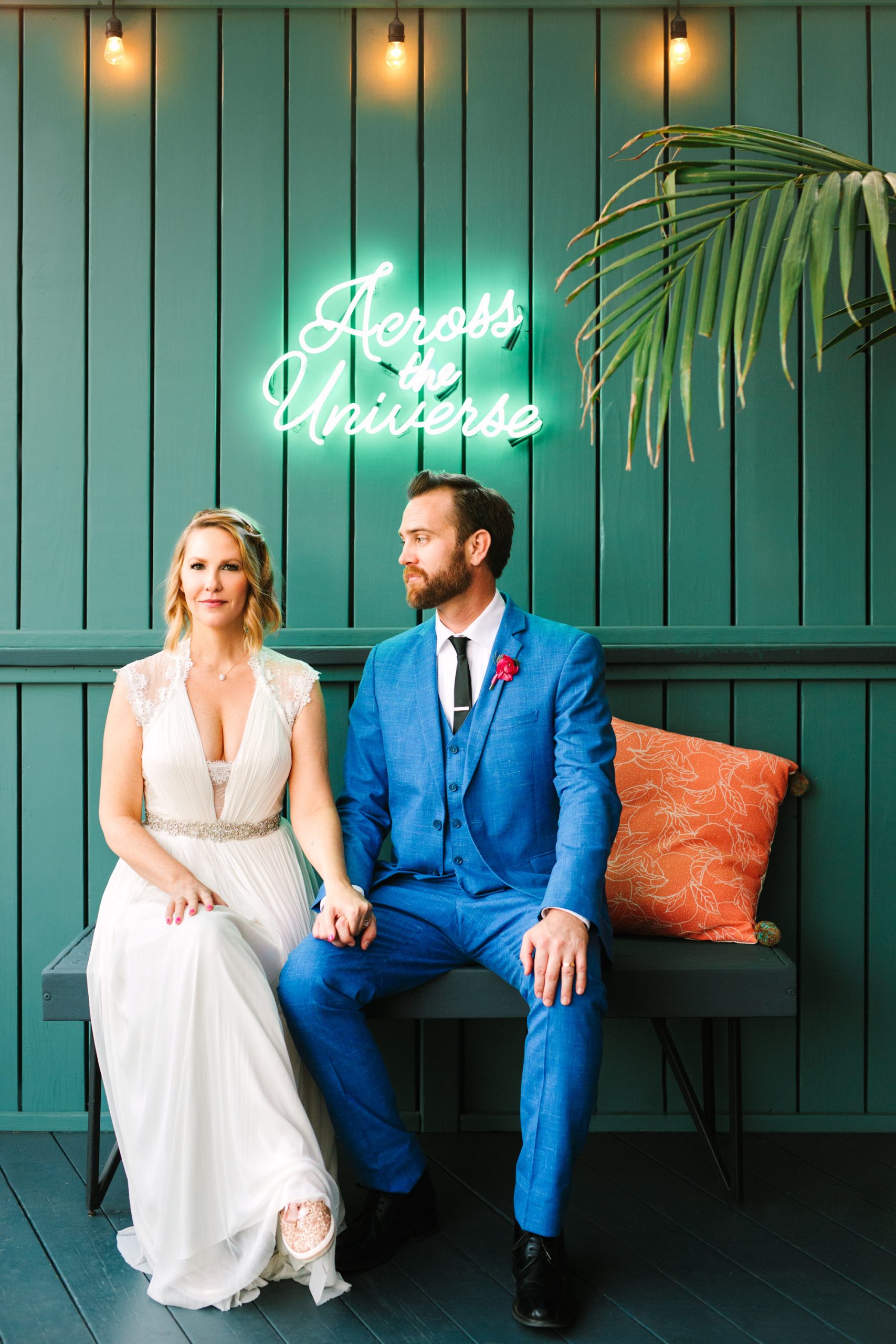 Bride and groom with Across the Universe neon sign at Ruby Street Los Angeles - www.marycostaweddings.com