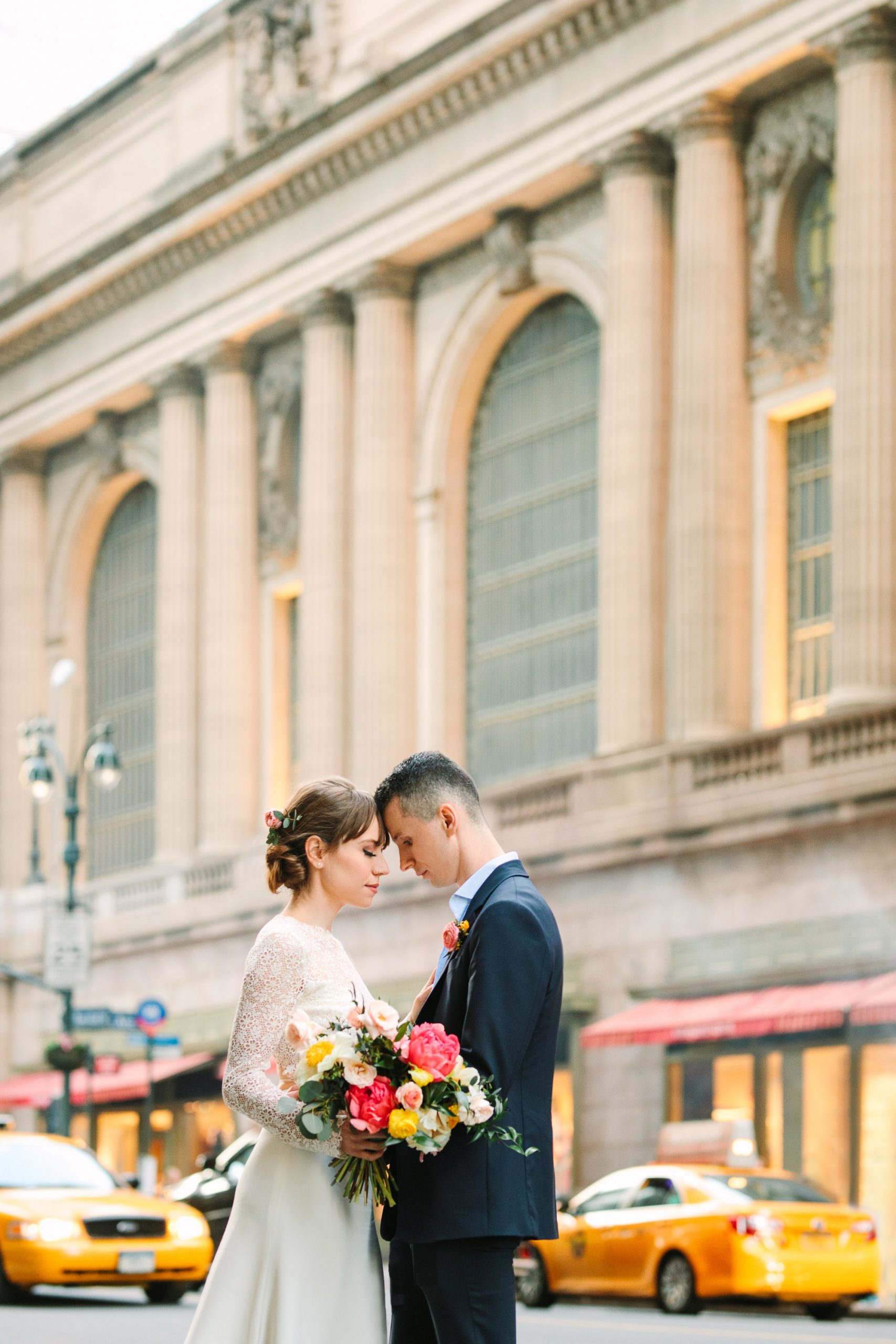 Bride and groom in front of NYC's Grand Central Station - www.marycostaweddings.com