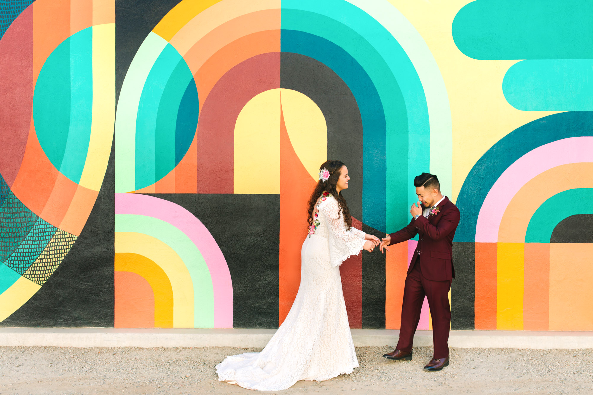 Bride and groom first look in front of colorful Jessie and Katey mural in Sacramento - www.marycostaweddings.com