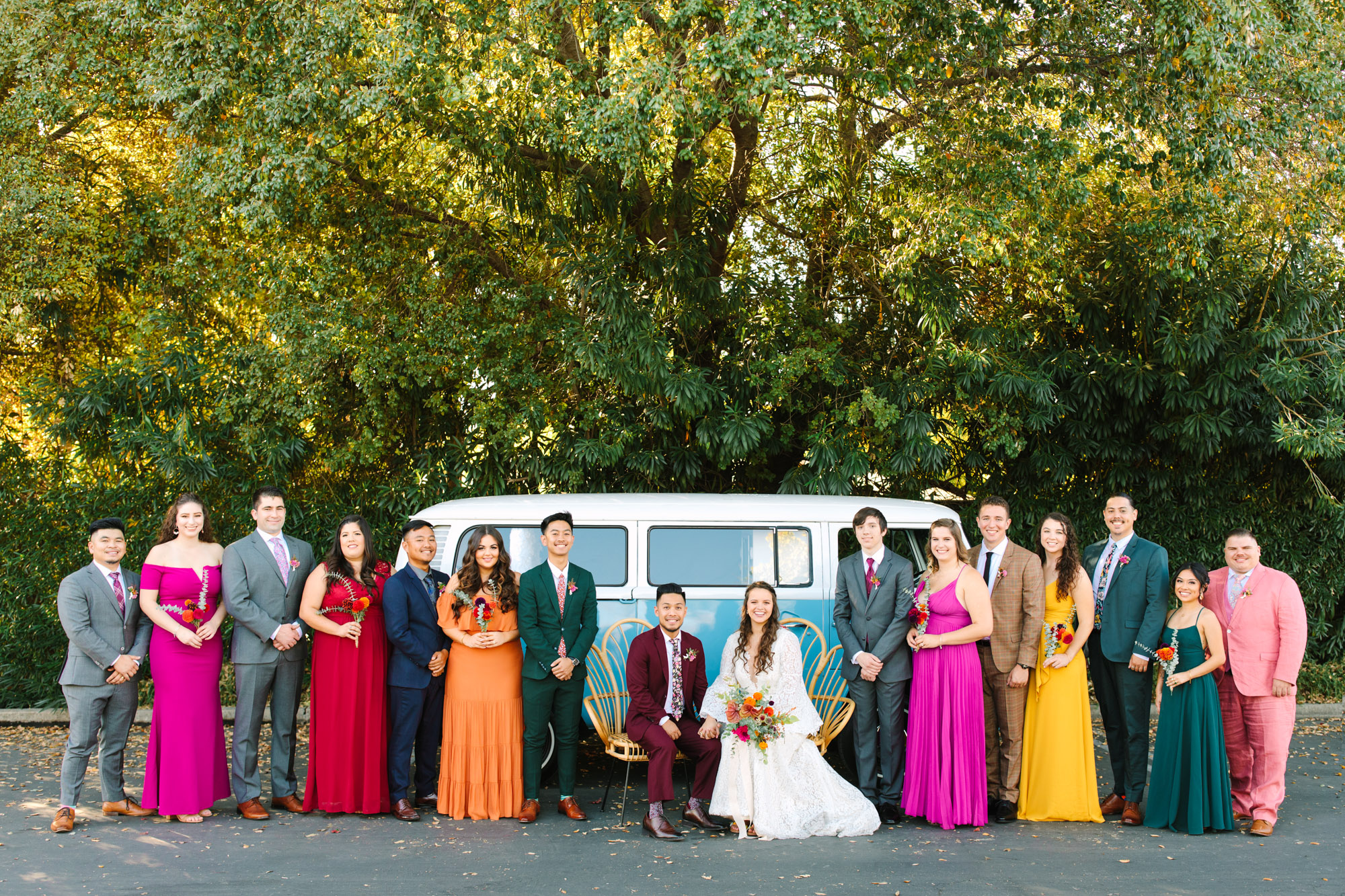 Colorful wedding party in assorted outfits posing in front of VW Van at BLOC Venue Roseville - www.marycostaweddings.com