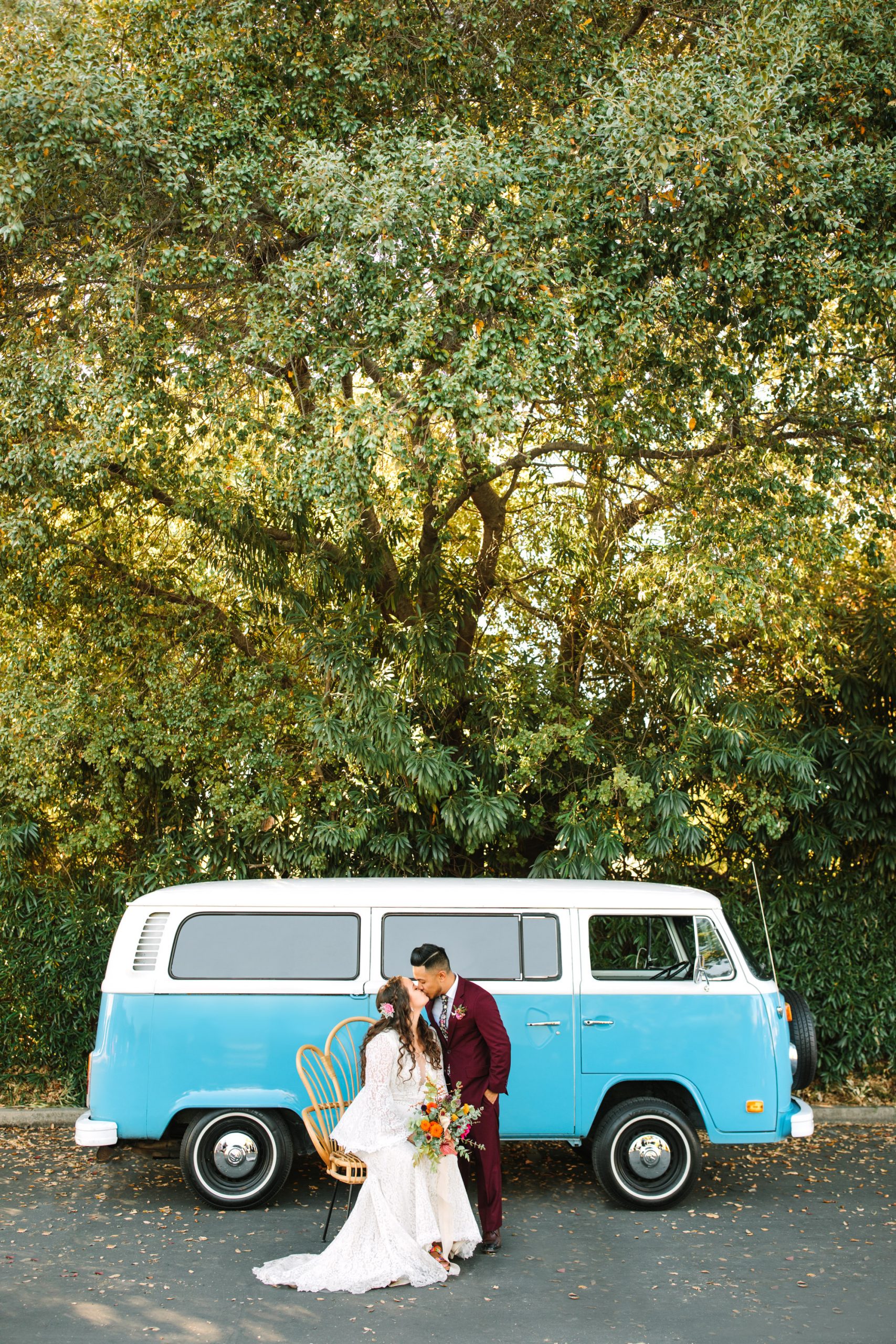 Bride and groom kissing in front of VW Van at BLOC Venue Roseville - www.marycostaweddings.com