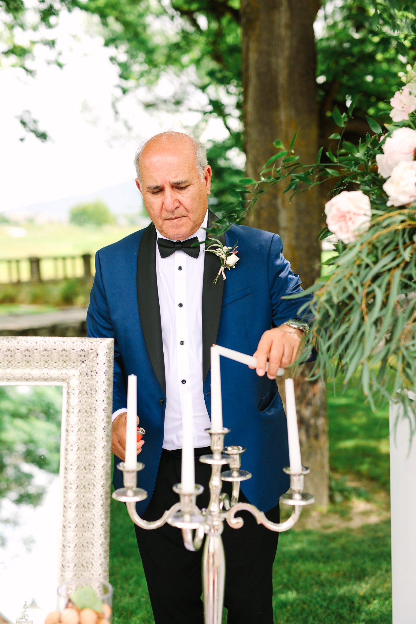 Groom's father lighting candle at Persian wedding ceremony. Millbrook Resort Queenstown New Zealand wedding by Mary Costa Photography | www.marycostaweddings.com