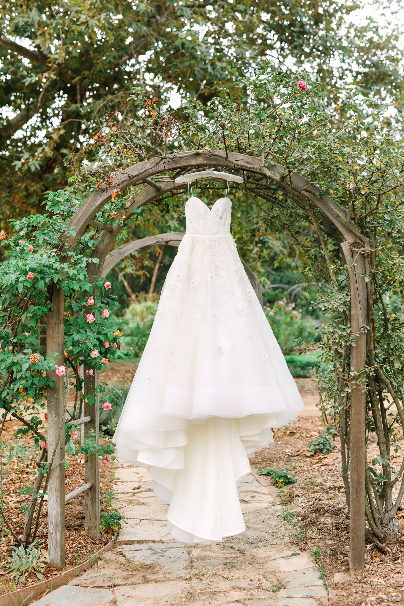 Wedding gown hanging at Descanso Gardens | Best Southern California Garden Wedding Venues | Colorful and elevated wedding photography for fun-loving couples | #gardenvenue #weddingvenue #socalweddingvenue #bouquetideas #uniquebouquet   Source: Mary Costa Photography | Los Angeles 
