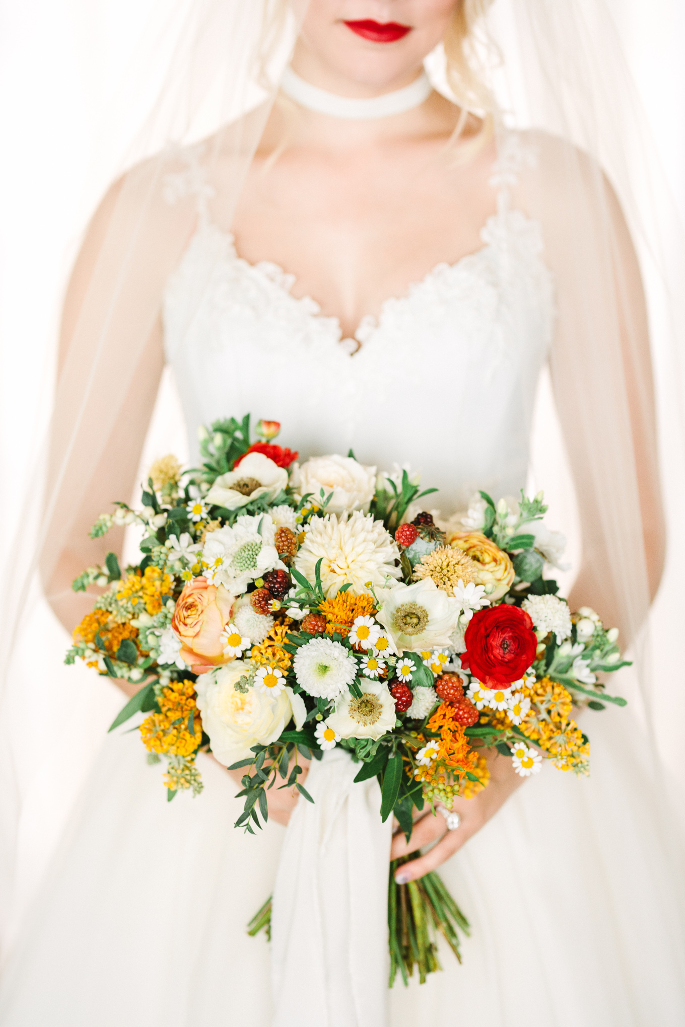 Whimsical yellow, orange, and red wedding flowers | Beautiful bridal bouquet inspiration and advice | Colorful and elevated wedding photography for fun-loving couples in Southern California | #weddingflowers #weddingbouquet #bridebouquet #bouquetideas #uniquebouquet   Source: Mary Costa Photography | Los Angeles