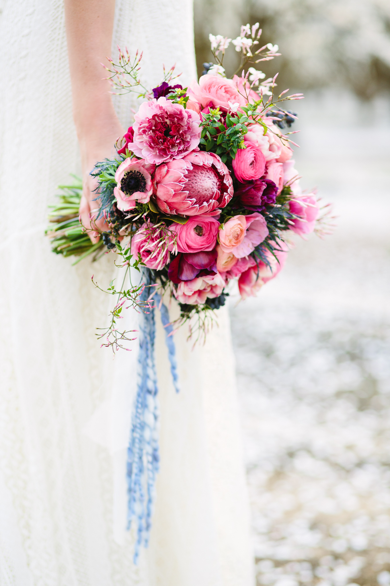 Boho protea and pink bouquet in an almond orchard | Beautiful bridal bouquet inspiration and advice | Colorful and elevated wedding photography for fun-loving couples in Southern California | #weddingflowers #weddingbouquet #bridebouquet #bouquetideas #uniquebouquet   Source: Mary Costa Photography | Los Angeles