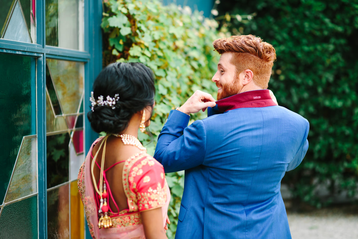 Wedding date on the back of the groom's suit jacket collar. Two Disney artists create a unique and colorful Indian Fusion wedding at The Fig House Los Angeles, featured on Green Wedding Shoes. | Colorful and elevated wedding inspiration for fun-loving couples in Southern California | #indianwedding #indianfusionwedding #thefighouse #losangeleswedding   Source: Mary Costa Photography | Los Angeles