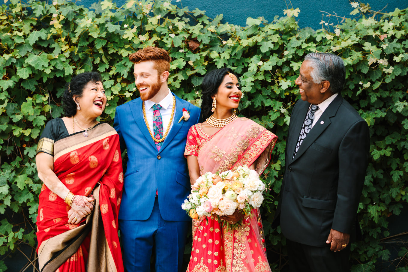 Laughing family portrait. Two Disney artists create a unique and colorful Indian Fusion wedding at The Fig House Los Angeles, featured on Green Wedding Shoes. | Colorful and elevated wedding inspiration for fun-loving couples in Southern California | #indianwedding #indianfusionwedding #thefighouse #losangeleswedding   Source: Mary Costa Photography | Los Angeles