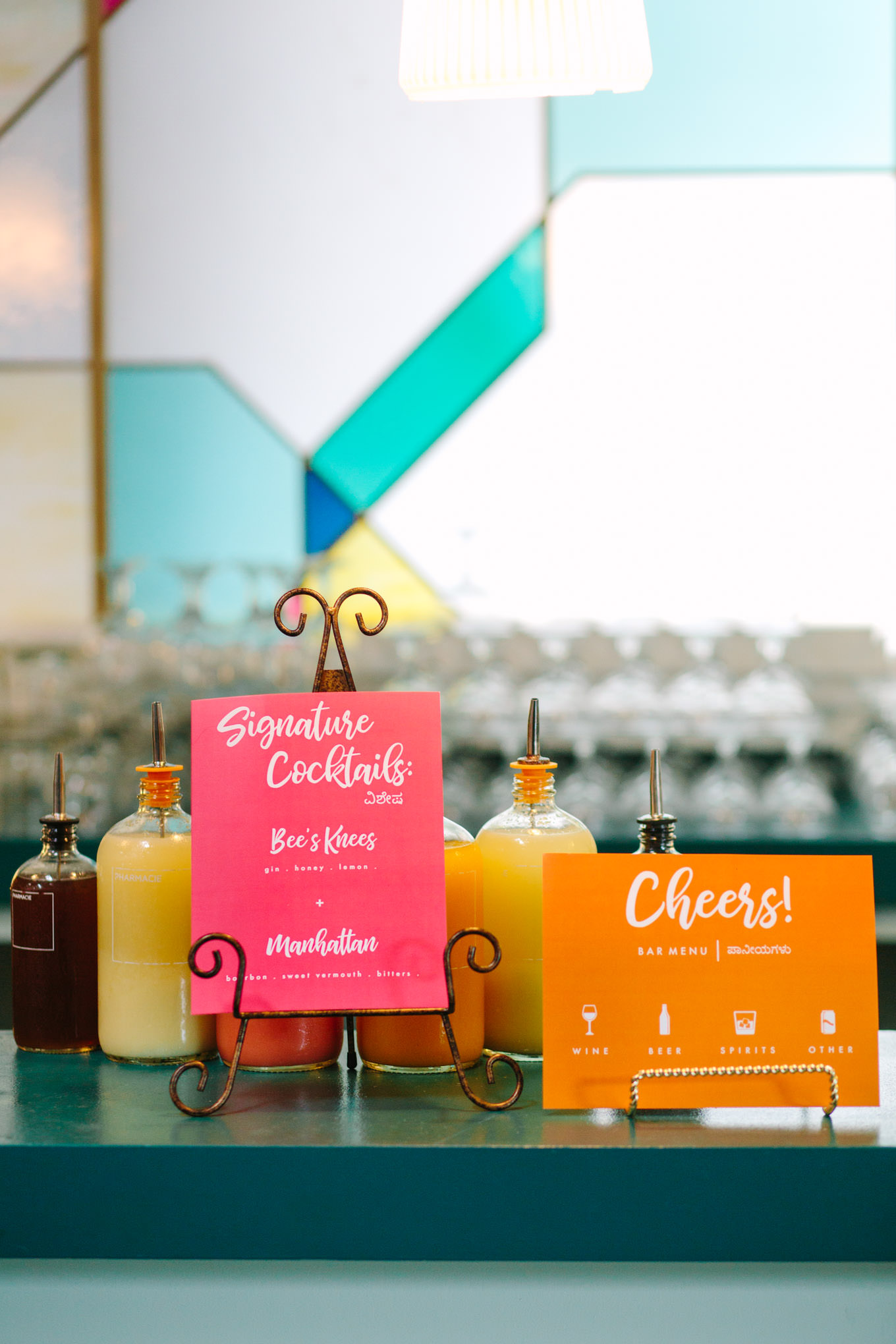 Custom bar signs at Fig House reception. Two Disney artists create a unique and colorful Indian Fusion wedding at The Fig House Los Angeles, featured on Green Wedding Shoes. | Colorful and elevated wedding inspiration for fun-loving couples in Southern California | #indianwedding #indianfusionwedding #thefighouse #losangeleswedding   Source: Mary Costa Photography | Los Angeles