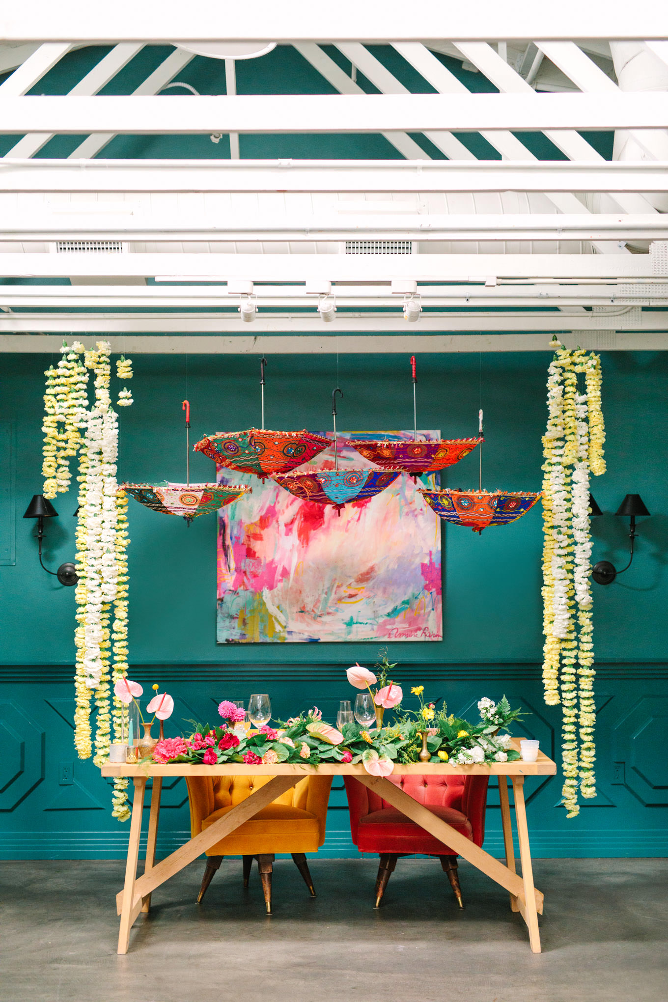 Colorful sweetheart table with cascading flowers by The Little Branch. Two Disney artists create a unique and colorful Indian Fusion wedding at The Fig House Los Angeles, featured on Green Wedding Shoes. | Colorful and elevated wedding inspiration for fun-loving couples in Southern California | #indianwedding #indianfusionwedding #thefighouse #losangeleswedding   Source: Mary Costa Photography | Los Angeles