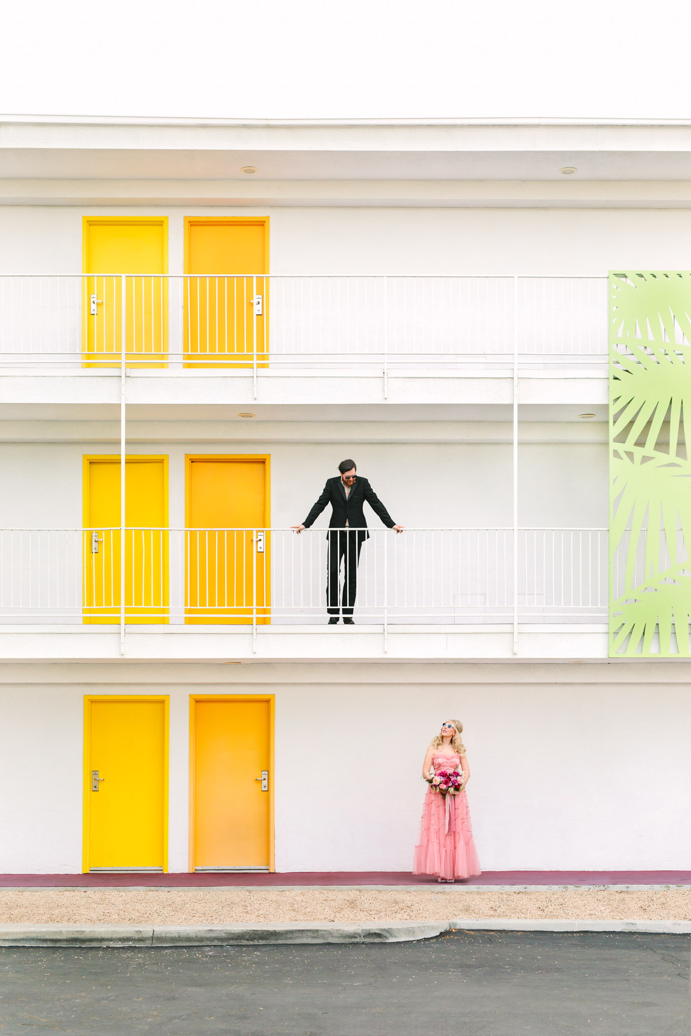 Retro-inspired couple at Saguaro Hotel. Modern vintage-inspired Palm Springs engagement session with a 1960s pink Cadillac, retro clothing, and flowers by Shindig Chic. | Colorful and elevated wedding inspiration for fun-loving couples in Southern California | #engagementsession #PalmSpringsengagement #vintageweddingdress #floralcar #pinkcar   Source: Mary Costa Photography | Los Angeles