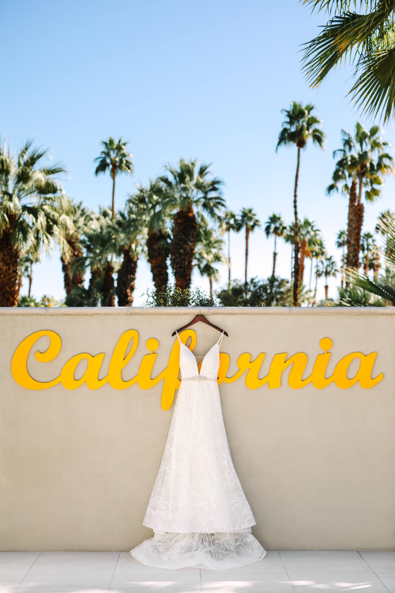 Wedding dress hanging in Palm Desert | Engagement, elopement, and wedding photography roundup of Mary Costa’s favorite images from 2020 | Colorful and elevated photography for fun-loving couples in Southern California | #2020wedding #elopement #weddingphoto #weddingphotography   Source: Mary Costa Photography | Los Angeles